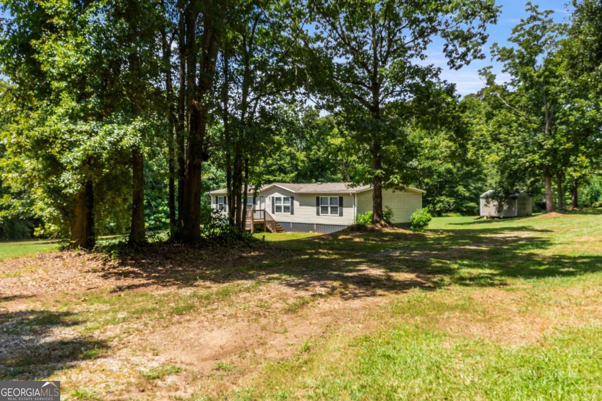 Peaceful & Serene 2.02 ACRES for that PERFECT MINI FARM in this coveted area of the county. Pull into this peaceful shaded oak driveway and view your own mini estate. Only 10 minutes to restaurants, shopping & travel access on I-85 or 441 yet in a peaceful area of the country you will love. The privacy of the home is amazing the way it is situated. The home is a 2017 newer home which was barely lived in. With LVP floors throughout & TWO LARGE living & dining areas you will love this beautiful home which features a large kitchen with island & a split bedroom plan with the master bedroom suite on one end of the home & two large bedrooms with a shared bath on the other end of the home. Great GARDEN SPOT, STORAGE BUILDING & LAND FOR your special use. You dont want to miss this great home at this great price & Location. Home is being cleaned on the exterior soon. Inside is pristine. Virtual staging helps you see how to place your furniture. Call for an appointment today!