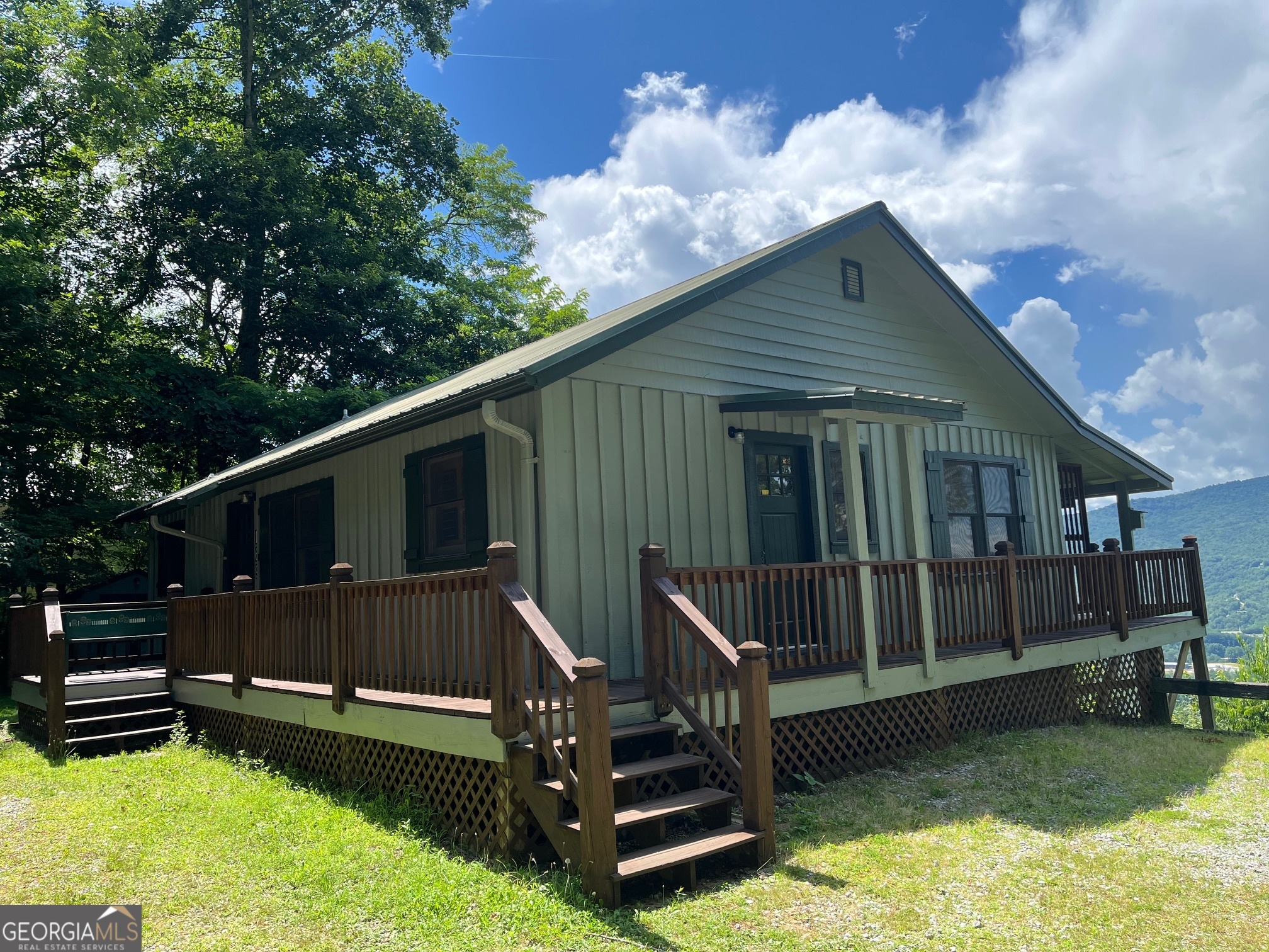 Incredible views from this cute 2/2 cabin! Very convenient to Clayton. High up on Screamer. Good road access. Great views of Black Rock State Park and north Clayton. You will spend most of your time on the back covered porch. Furnishings negotiable. Extra lot is included in this sale.