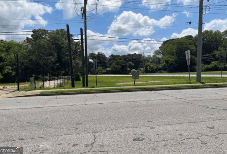 Prime undeveloped high traffic count commercial corner lots in the very heart of downtown Fayetteville. This tract straddles both sides of State Highway 54 with the bulk of land being on the south and a smaller somewhat triangular lot on the north.  Fee simple across State Highway 54 is a bifurcated lot straddling the highway. These two lots may be bid *separately or together*, designating north or south lot.