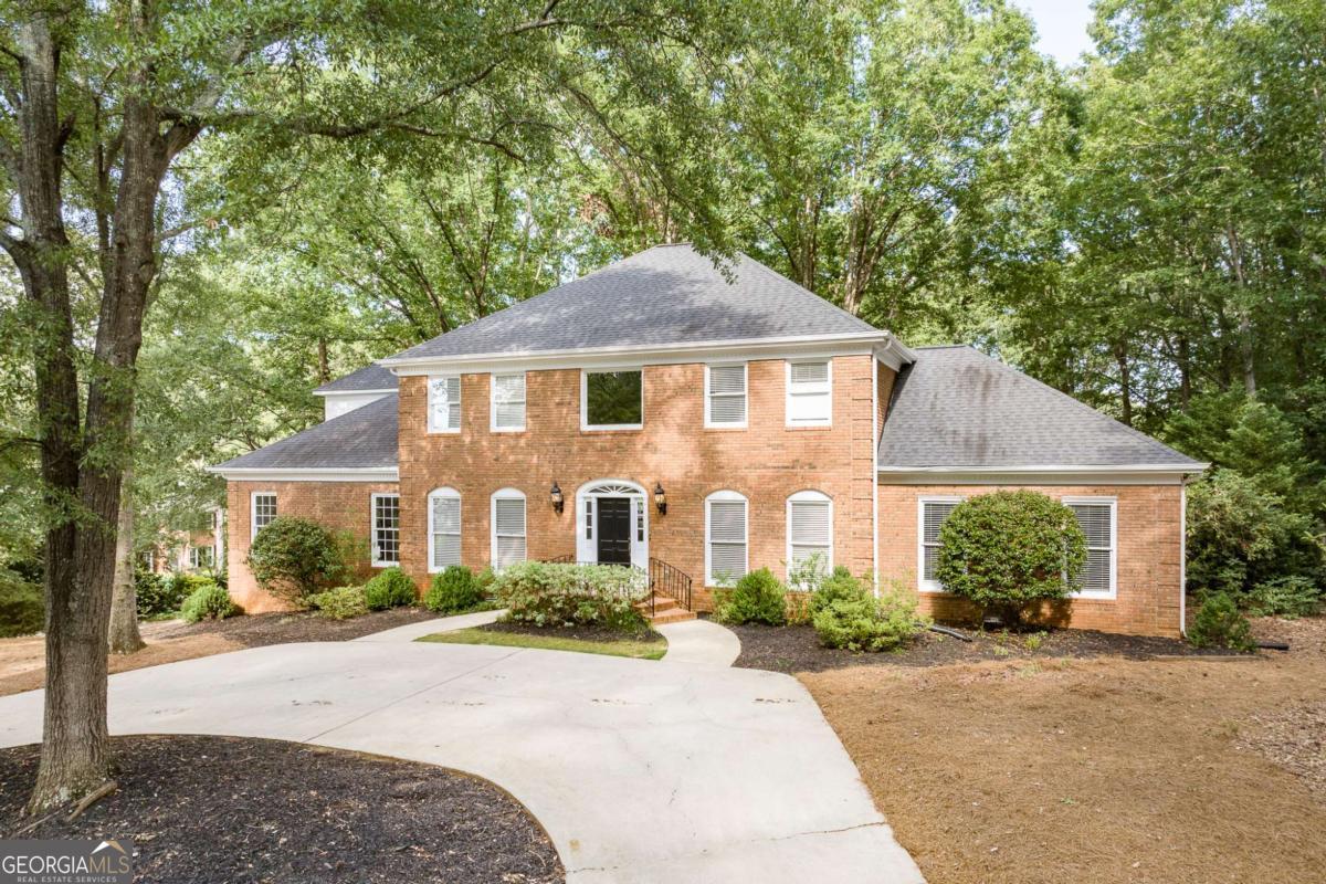 Nestled in Glen Oaks, a highly sought-after neighborhood in West Athens, this stunning residence sits proudly on a beautiful corner lot and boasts the perfect balance of timeless charm and modern comfort. From the moment you arrive, the circular driveway welcomes you with graceful sophistication and hints at the elegance that lies beyond the front door. This home is a rare blend of classic design and thoughtful functionality-all situated just minutes from public and private schools, shopping centers, fine dining, and all the conveniences of in-town living, while still providing a serene and quiet retreat from the bustle. Step inside to a bright and inviting foyer, where rich architectural details, warm natural light, and hardwood floors immediately establish a sense of style and scale. Whether youre entertaining guests or enjoying a cozy evening in, the living spaces here rise to every occasion. A formal dining room awaits just off the entry-ideal for hosting family holidays or intimate dinner parties. Beyond the dining room, you'll find a spacious, thoughtfully designed kitchen. Featuring solid surface countertops, stainless steel appliances, a spacious pantry, and a tile backsplash, the kitchen flows effortlessly into a sunlit breakfast area, perfect for casual dining or weekend brunches. One of the standout features of this home is the primary suite located on the main level, offering rare convenience and privacy. In addition to ample closet space, youll find a private en-suite bath with double vanities, a soaking tub, and a separate shower-designed to be your retreat at the end of a long day. Upstairs, you'll find four additional generously-sized bedrooms, each with ample closet space and access to well-appointed bathrooms. Whether you're accommodating family, guests, or setting up secondary offices or creative spaces, the home offers flexible room arrangements that grow with your needs. Enjoy the best of Georgia living with a resort-style backyard that invites you to relax, play, and entertain. The crown jewel of the outdoor space is the sparkling in-ground pool, surrounded by mature landscaping and plenty of patio space for lounging, dining, and hosting summer get-togethers.