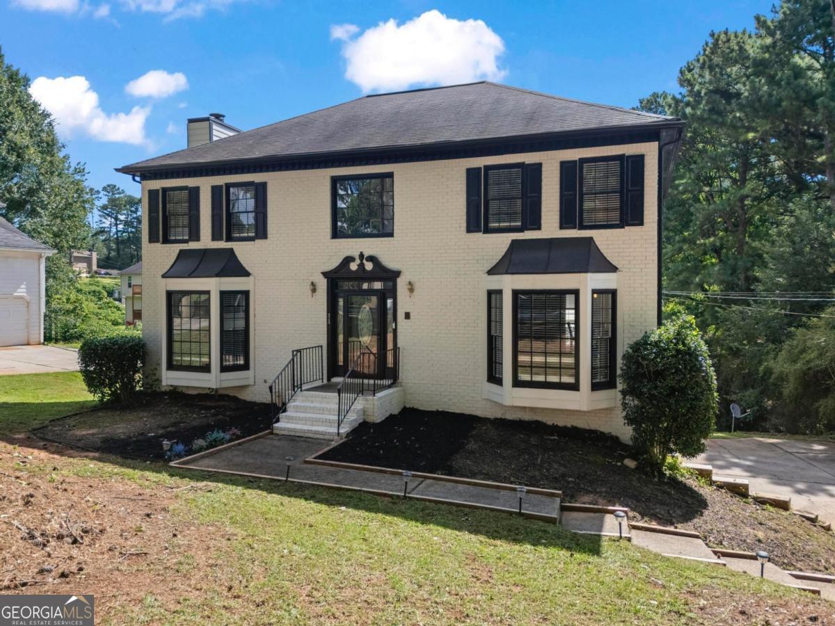 This fully renovated 4 bedroom, 2.5 bath home, offers over 3,100 square feet of living space and is located in the well established, NON-HOA tennis community of Brookglen. Step inside and you are welcomed by an inviting foyer. To the right is the spacious formal living room (with a bay window) and a separate formal dining. The modern, eat-in kitchen features stone countertops and a full stainless steel appliance package that remain with the home. Off from the kitchen is the sun-filled family room, with a bay window (at the front) and floor-to-ceiling windows overlooking the backyard. On the upper level, you will find an open landing with a large window that floods the space with morning light. The large master bedroom is directly to the right and offers peace and quiet away from the secondary bedrooms. With a spa-like ensuite and walk-in closet, it is the perfect retreat after a long day. Down the hall, 3 bedrooms and a full bath are tucked away in their very own corridor--a literal "kids zone," if you will. The laundry is conveniently located in the hallway and completes the upper level beautifully. The lower level features a finished, walk-out basement and oversized 2-car garage with plenty of storage space. Located only minutes from grocery stores, schools, pharmacies, gas stations, parks, restaurants, and interstates I-20 and I-285, this beautiful home is well maintained, move-in ready, and perfect for a growing family. Come tour your forever home TODAY!