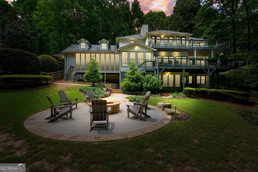 This stunning custom built Lake Front home boasts just over an acre of peace, privacy, and possibility, tucked away in desirable Cherokee County. Bordering Army Corps of Engineers property, you can rest assured there will be no new neighbors building nearby. Just moments from Eagle Watch Golf Club, Bridgemill Golf Club, premier nature trails and parks, highly rated schools, and shopping in Downtown Woodstock or at The Mill on Etowah. With no HOA restrictions, you can keep your boat parked in the yard, or at your dual level party dock. A short boat ride over to JD's on the Lake for dinner, formerly "Blue Cat Lodge", made famous by the Netflix series "Ozark", which the dual level party dock to this property had a cameo on! "Season 1, Episode 5"! This Lake Front dream features a total of seven bedrooms, which includes two Primary suites, one on the main-level, both with expansive decks and year round views of Lake Allatoona. The larger Primary suite upstairs is appointed with the most gorgeous views, complete with a spacious coffee bar, custom walk-in closets, an oversized double shower, beautiful soaking tub, and sitting area just awaiting your retreat. The unique bedroom off the upstairs Primary would make for a great nursery, office, or yoga studio with tranquil views. There are four bedrooms in total upstairs, all complete with a lake view, as well as a washer/dryer closet off the hallway. The impressive chef's kitchen ensures effortless hosting, giving way to the picturesque sun room, screened in back porch, and extensive decking, offering all seasons enjoyment with lake views. The professionally landscaped yard, stacked stone fire pit, and calming custom water feature solidify this backyard oasis as your family's forever sanctuary. Additional main-level features include a well-appointed mud-room with washer/dryer connections, a large light-filled office with built in bookcases, oversized dining room perfect for all the family gatherings, and a cozy sun drenched living room with a stately fireplace. The finished basement has a media room with fireplace, a wine room with built in cabinets, two large bedrooms, a full bathroom, and a spacious separate area for storing fishing poles, life jackets, seasonal decor, etc. The detached three car garage offers additional storage above. The dual level party dock is accessed via a short trail through the Army Corps of Engineers property. Secluded yet convenient, and a rare offering in Woodstock, come experience the endless possibilities Lake Life has to offer in this premier location!