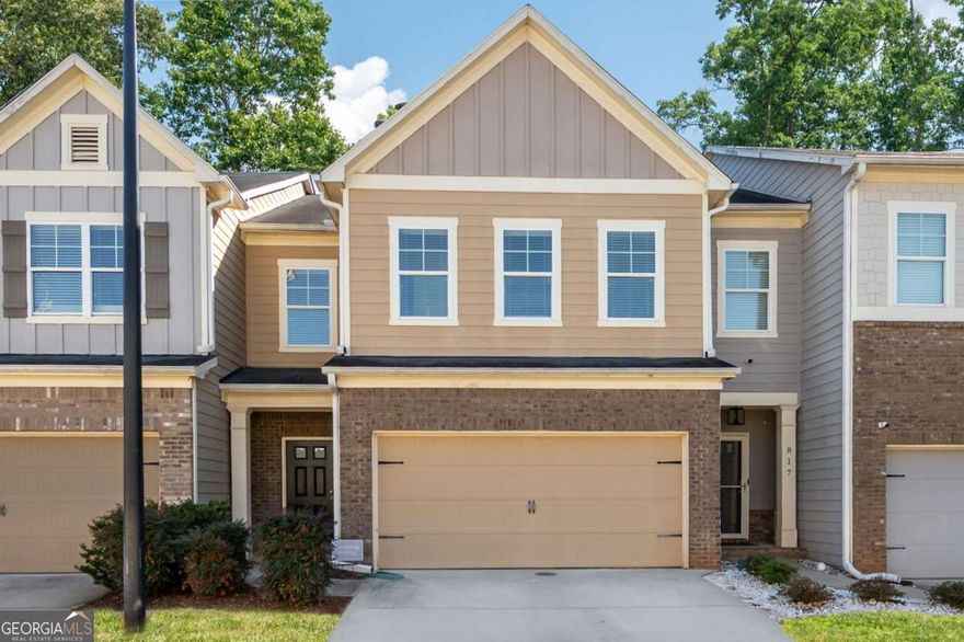 Step into the comfort and style. This beautifully appointed 3 BR/2.5 BA townhome in Marietta is ready for it's new owner. Sellers can CLOSE QUICKLY. The open-concept floorplan and modern amenities create the perfect setting for relaxation and entertainment. The main level welcomes you with gleaming hardwood floors that extend throughout. The living room, centered around a striking gas fireplace, provides a warm, inviting atmosphere for gatherings or quiet evenings at home. Adjacent to the living area, the eat-in kitchen features GRANITE countertops, stainless steel gas appliances, and a walk-in pantry. The kitchen opens to a charming deck offering PRIVATE serene backyard views. A convenient half bath on the main floor adds functionality. Upstairs, the spacious primary bedroom serves as a private RETREAT, complete with a sitting area, stylish accent wall, and tray ceiling. The large walk-in closet provides ample storage, while the ensuite bathroom boasts a double vanity, separate shower, and bathtub. The home's bathrooms were UPDATED with new vanities and fixtures last year. Two additional large bedrooms feature spacious closets and share a well-appointed full bathroom. The laundry room, conveniently located upstairs, ensures easy access. This townhome also includes a two-car garage, providing plenty of space for vehicles and additional storage. Located close to local amenities and offers a blend of modern living and a convenient location, making it an ideal choice for anyone looking to live in Marietta.