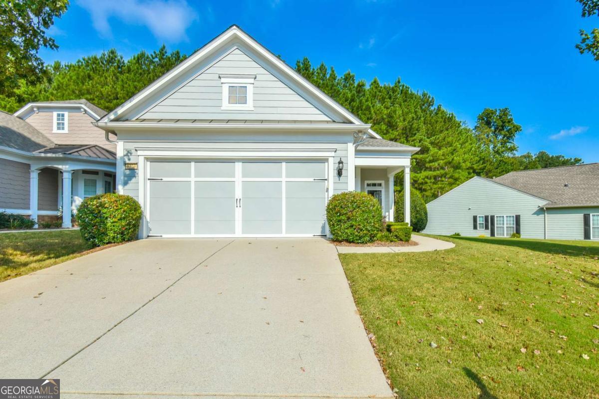 Come check out this move-in ready home. This Fox Run floorplan is a wonderful model for someone who is ready to downsize. It is 2 bedrooms/2 bathrooms, sunroom and a patio w/ retractable awning. The house has a great, level lot with extra space between you and your neighbor! The kitchen has hardwood floors, granite counter tops, and tile backsplash. Master closet has a custom closet system. Located in 55+ gated community of Village at Deaton Creek. This established community hosts 2 pools, pickleball, bocce ball, tennis, softball, dog park and walking trails. Over 100 clubs to join. Doesn't it sound a little like Adult summer camp? We think so!