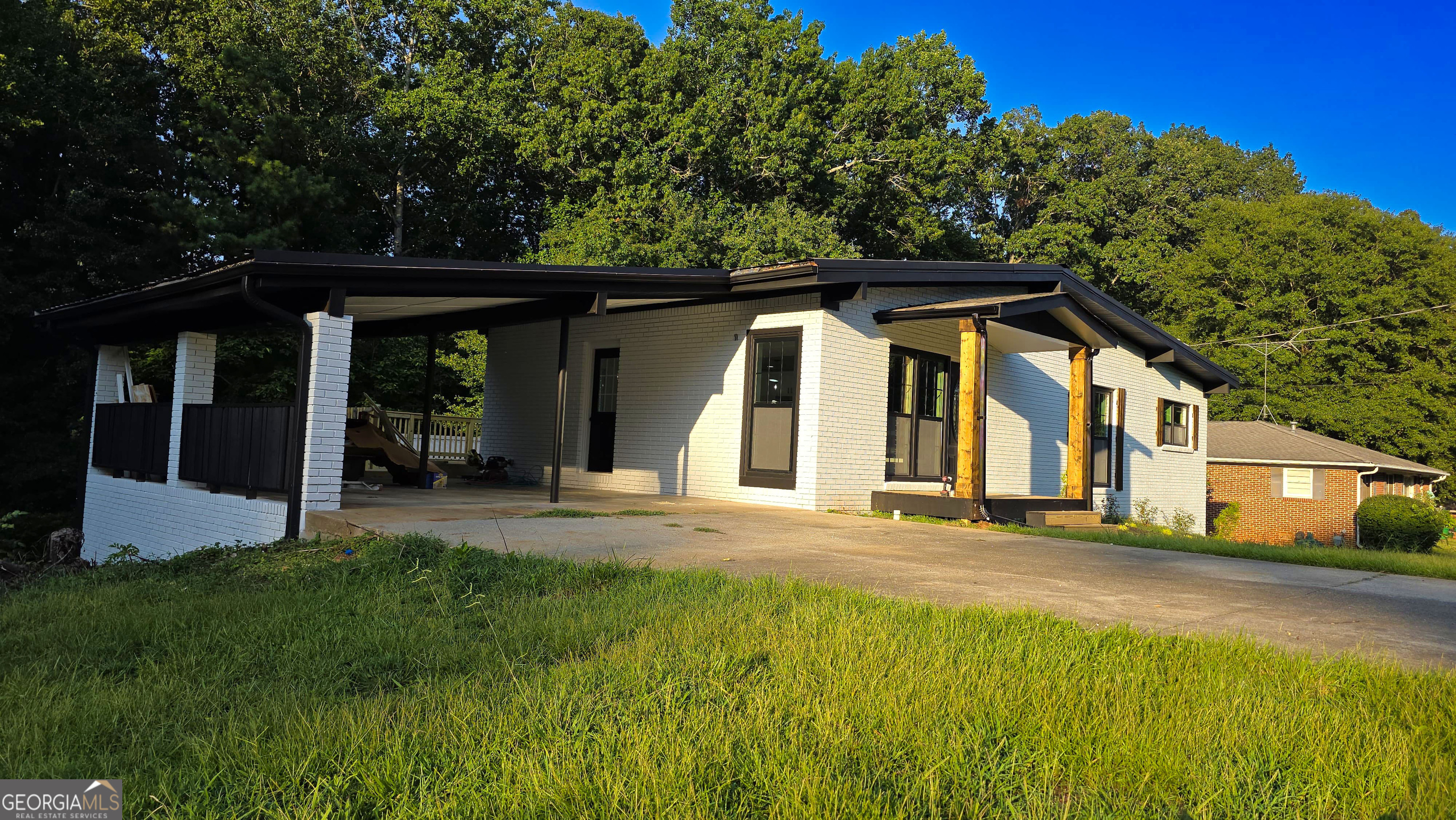 Stunning completely renovated ranch-style home with a fully finished basement and kitchenette, ideally located in the heart of Sugar Hill, nestled in a beautiful and established neighborhood.?? $5,000 Preferred Lender Closing Cost Incentive! Designed thoughtfully for modern living, this spacious 4-bedroom, 3-bathroom home seamlessly blends luxury, comfort, and convenience. From the moment you walk in, you'll notice high-end finishes, including elegant and durable LVP flooring throughout. The open layout flows beautifully from a welcoming foyer to a bright family room featuring a cozy gas fireplace-perfect for relaxing or entertaining. The kitchen is a true centerpiece, boasting custom cabinetry, gleaming quartz countertops, and ample workspace. A separate formal dining room sets the perfect stage for dinner parties and holiday gatherings. The layout includes four spacious bedrooms and three full bathrooms, including a luxurious and generously sized master suite with en-suite bath. Step outside to enjoy the expansive 0.64-acre backyard, complete with a 400-square-foot carport, new deck and porch, and a 1340 storage shed-ideal for storage or a full workshop. A dual driveway adds extra convenience and parking space. Located just minutes from Sugar Hill's vibrant downtown, top-rated parks, shopping, and dining, this home offers the perfect combination of privacy and accessibility. Don't miss this exceptional gem! Schedule your showing today.