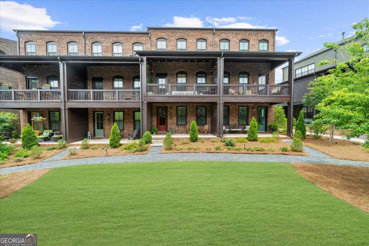 This is the BEST VALUE in Halcyon! One of Alpharetta's most vibrant live-work-play communities! Imagine having restaurants, boutique shops, entertainment, fitness studios and a brand new Trader Joe's and Chick-Fil-A just outside your doorstep. This is the walkable lifestyle you've been dreaming of! Perfectly situated within the community, this home is mere steps from the Big Creek Greenway and just a short stroll to the community's pool, clubhouse, green space and fire pit. The thoughtful upgrades throughout take this home to the next level. Inside, you will find an open-concept layout designed for modern living and entertaining. With 3 spacious bedrooms, 3.5 bathrooms, and two covered porches overlooking the courtyard, every inch of this home feels curated for comfort and style. On the entry level, there is a welcoming foyer with a custom built bench, coat rack and shelving leading to a bedroom ideal for guests, home office or gym with a full bath featuring a frameless glass shower. Head upstairs to the gourmet kitchen, a true showstopper with a microwave drawer, gas range, Quartz countertops, tiled backsplash to the ceiling, upgraded vent hood and ceiling-height cabinets. The spacious pantry with custom Elfa shelving optimize its functionality. The kitchen overlooks both the family and dining areas, creating a seamless space for entertaining. Step outside to the second-floor covered porch featuring a jasmine plant lattice wall and views of the courtyard. This is where you are going to love having your morning coffee cozied up with a book. The upper floor hosts the luxurious primary suite, complete with his-and-hers Elfa custom closet systems, a spa-like bathroom with double vanities and an oversized frameless glass shower. You will also find a secondary bedroom with an ensuite bath on this level. Additional upgrades include: in-ceiling speakers, 1ft thick walls with extra insulation for maximum noise cancellation, Tesla charging station in the garage, West Elm light fixture in the dining room, space-saving sliding barn doors leading to the primary bath, and enhanced storage with upgraded cabinetry in the kitchen, bathrooms and laundry. This townhome combines the best of luxury, low maintenance and lifestyle given its prime location. Plus, you are minutes from GA-400, Avalon and Downtown Alpharetta. Schedule your private tour today and experience the Halcyon lifestyle firsthand!
