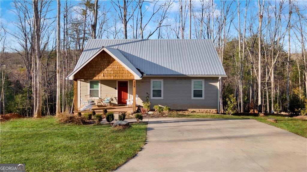 Welcome to Your North Georgia Mountain Getaway! Escape to the beauty of the Blue Ridge Mountains at 374 Prince Drive, a modern mountain retreat that perfectly balances peace, comfort, and convenience. Whether you're looking for a cozy family retreat, a second home, or a smart investment with short-term rental potential, this property checks every box. A rare find in the Lake Blue Ridge community, where homes rarely come on the market, this retreat offers the best of mountain living with Lake Blue Ridge Beach access just half a mile away. Built in 2021 with quality craftsmanship, the home is low-maintenance and designed for both everyday living and memorable getaways. Step inside to find warm hardwood floors, soothing neutral tones, and a modern cabin-style living area. The open-concept design flows seamlessly from the living room into the spacious kitchen, complete with a large island, abundant cabinet storage, and generous countertop space. From here, step right out onto the back porch overlooking the gentle, tree lined backyard perfect for morning coffee or evening relaxation. As the crisp mountain air rolls in this fall, you'll love gathering with friends and family around the outdoor brick fireplace, set along a stone walkway, for marshmallow roasting and starlit conversations. Conveniently located just 10 minutes from Downtown Blue Ridge and its charming restaurants, shops, and trails and only 15 minutes to McCaysville for even more outdoor adventures. You'll always be close to the best of North Georgia. Whether you're searching for a mountain escape, a rental investment, or a place to create lasting memories, 374 Prince Drive is the perfect fit. Don't miss your chance to own a slice of Blue Ridge-schedule your showing today!
