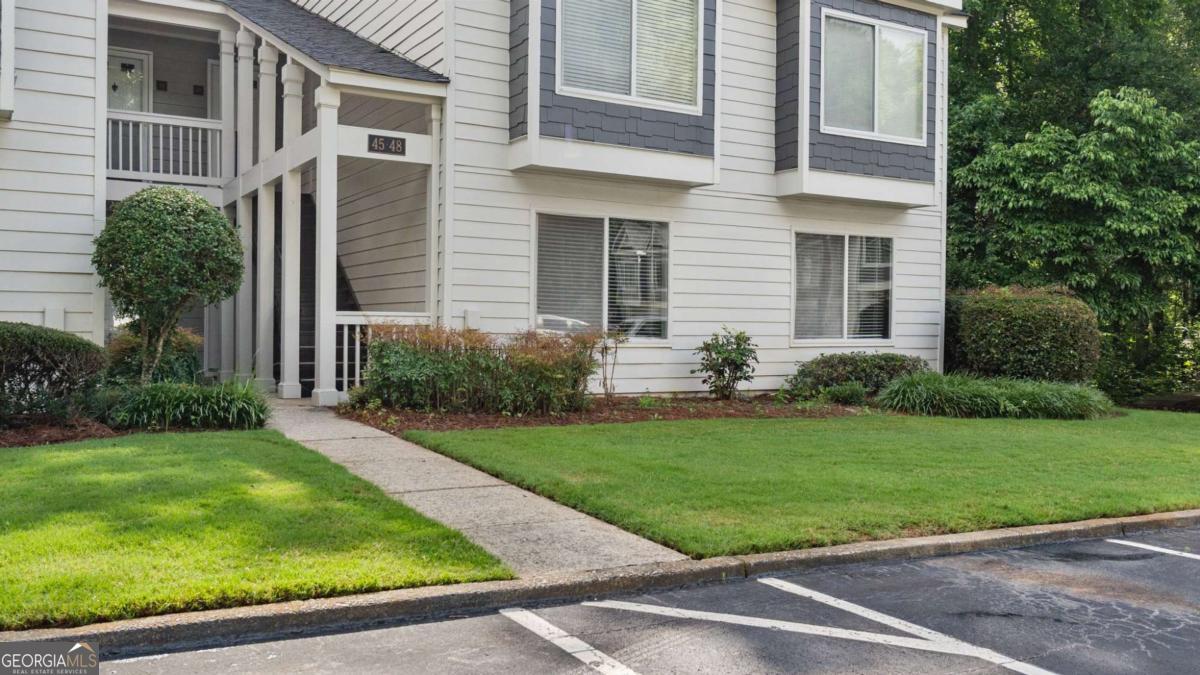 Welcome to this beautifully updated 2-bedroom, 2-bathroom condominium offering style, comfort, and convenience just minutes from Truist Park and The Battery! Step inside to discover a bright, open living space featuring accent walls, recessed lighting, and a cozy fireplace-perfect for entertaining or unwinding after a long day. The kitchen is a true standout with granite countertops, stainless steel appliances, a farmhouse double-bowl sink, and a dedicated coffee bar and pantry area. Enjoy morning coffee or evening cocktails on your private covered patio-complete with extra storage space. Retreat to the spacious primary suite featuring an updated bathroom with a stepless shower for added comfort and accessibility. Both bathrooms have been tastefully renovated to reflect modern design trends. Located just moments from top-tier shopping, dining, and easy interstate access, this home is ideal for those who want the best of city living with a quiet, stylish retreat to come home to. Don't miss this move-in-ready gem in one of the most sought-after areas near Atlanta!