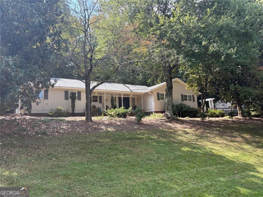This is the unique custom ranch that you have been waiting for. Renovated 4 Bedroom / 3 Bath one level home nestled on a private 1.5 acre lot. All this, yet you are located just minutes from I-75, downtown Marietta, and Town Center. Open floor plan features a spacious Family Rm and adjacent Dining Room that offers an abundance of natural light. The added Den is without a doubt the place that you will find yourself drawn to. A Wonderful kitchen includes white cabinets, granite counters, and SS appliances. The huge Master Suite is like no other and showcases a truly elegant Vaulted Master Bath that you won't find elsewhere. The 4th Bedroom / Office is absolutely perfect for the "work at home" professional. When it is time to relax, head out to the back patio as you will enjoy the waterfall and koi pond. No need to store the boat or RV as there is ample parking available. You don't want to miss this one!