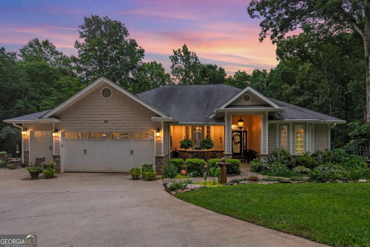 Craftsman ranch on 1.9 + acres in a private Lake Lanier neighborhood minutes from GA 400 with no HOA. Hardwood floors, 10'+ ceilings, double-sided wood-burning fireplace and transom-topped casement windows throughout the main level, with thoughtfully detailed and rarely available smooth corner walls. Primary Suite is a sanctuary unto itself with its wood paneled walk-in closet and a spa bathroom complete with an arched ceiling and lots of natural light. French doors open to a covered screen porch, perfect for chilly fall mornings, watching nature, or just listening to a rainy night in Georgia-additional guest bedroom with private bath on the main level, plus a half bath in the hall. Large living space on the terrace level with a kitchenette makes entertaining a breeze. 2 additional bedrooms, a large office/media flex space, a full bath, and walk-in storage finish out the sun-filled walk-out level with french doors that open to a spacious covered porch. Creek branch with natural spring runs through the middle and empties to the lake. Like the house? Wait until you see the gardens. Meticulously planned to be surrounded by constantly blooming heirloom plants, every day is an adventure. So many species of iris, day, tiger, and Asiatic lilies, Lenten roses in the winter, azaleas and Chinese Cherry trees in the spring, hydrangeas showing out in the summer, and Aster from the Atlanta Botanical Gardens heralding fall. The perfect amount of space for your favorite vegetables next to the established herb garden. The pool and the decks are just icing on the cake...(You will be surprised how much you like that pool...)