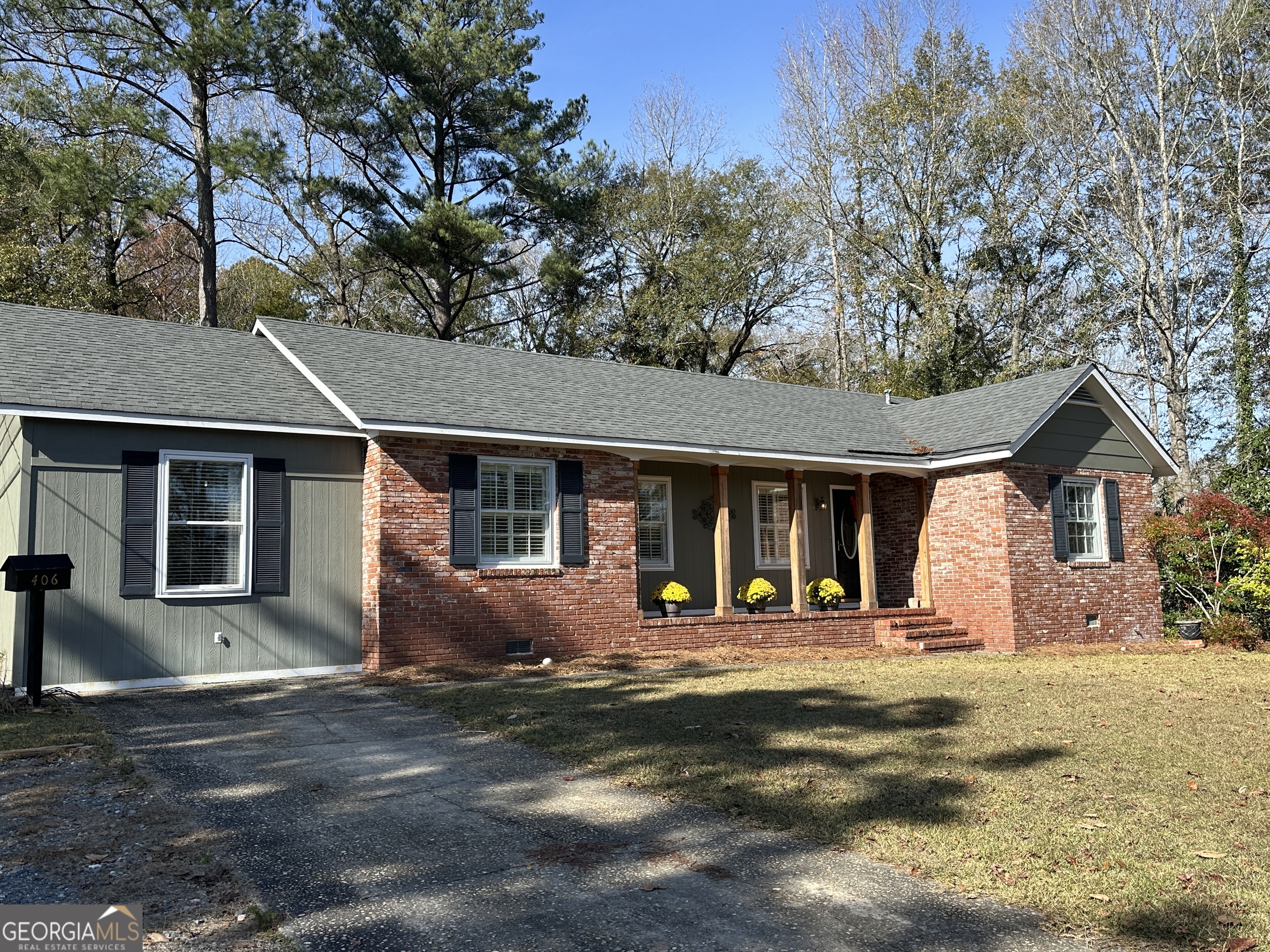 Renovated 4-bedroom, 2.5-bath residence spanning 2,167 SqFt. Located on a .48-acre fenced lot in the heart of Manchester, Meriwether County. The foyer leads to a well-lit front living room adorned with plantation shutters. The updated tile kitchen boasts custom cabinetry, stainless steel appliances, natural gas cooktop, breakfast bar island, and a dining area seamlessly connected to the living room. A cozy den with a wood-burning fireplace opens to a spacious screened porch, ideal for grilling and entertaining. The front and middle bedrooms share a beautifully renovated tile bath with a tub/shower combo. The generous primary bedroom features an updated bathroom with a tile shower, separate whirlpool tub, and a walk-in closet. The fourth bedroom with a half bath serves as a perfect man cave for watching your favorite ball game. Enjoy a large fenced private backyard with a fire pit and a separate fenced dog run/kennel area. Connected to city water & sewer and high speed internet available. Only 25 minutes from FDR State Park and Pine Mountain, under 50 minutes from Peachtree City, Columbus, and Lagrange, and just 75 minutes from Hartsfield-Jackson Atlanta International Airport.