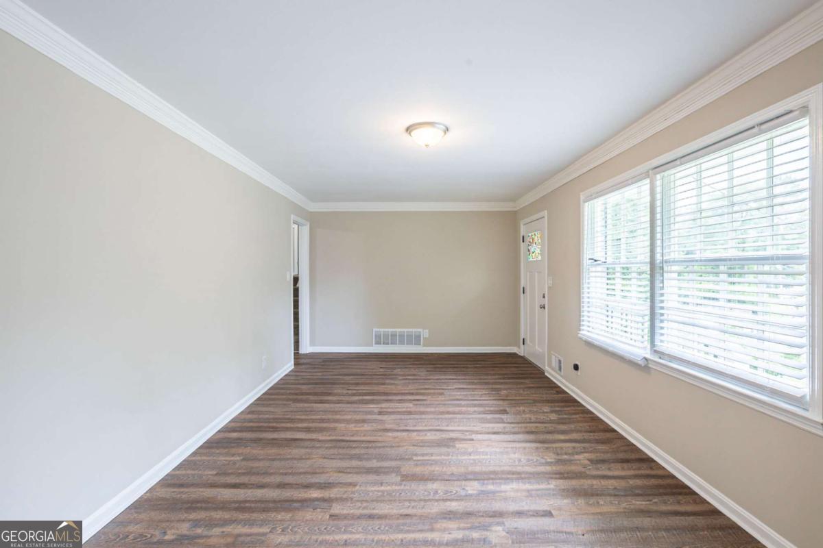 This spacious multi-level home offers 6 bedrooms and 3 full bathrooms, providing room to spread out and grow. The inviting living room features a cozy fireplace, perfect for relaxing evenings. The kitchen is both stylish and functional with sleek white cabinets and beautiful granite countertops. A 2-car attached carport adds convenience and shelter, making everyday living even easier. Schedule a showing today!