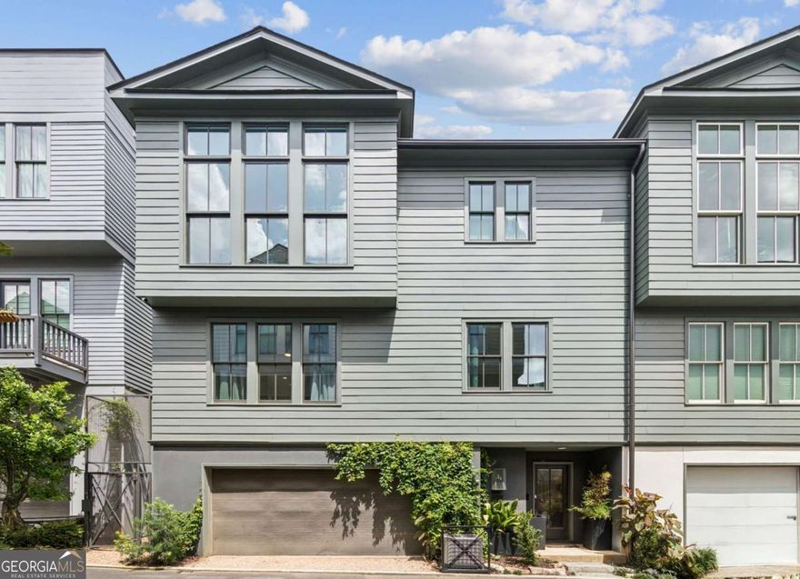 Welcome to luxury living in the heart of vibrant Summerhill! This three-story townhome blends thoughtful design with high-end upgrades and smart home features-offering comfort, convenience, and unbeatable access to everything Atlanta has to offer.    Step inside through the custom mudroom entry with a built-in dog nook and closet. The second floor features two spacious ensuite bedrooms with 9' ceilings, Brizo shower fixtures, 8' custom doors, and soft-close cabinetry with in-drawer outlets. The primary suite includes a walk-in closet with built-in laundry, a pocket-door master bath with dual vanities, a dimmable lighted makeup mirror, and a sleek Ream whole-home air filtration system.    Upstairs, the top-floor living space is a showstopper. Soaring 12' ceilings, floor-to-ceiling windows on three sides frame stunning views of downtown Atlanta and the Capitol. The 7-speaker surround sound system adds built in ambiance. Entertain in the chef's kitchen with an 8' quartz island, 5-burner gas stove, instant hot water, dual-zone oven that can operate as an air fryer, beverage fridge, one of a kind microwave drawer, and walk-in pantry with custom cabinetry and lighting. Cozy up by the gas or wood-burning fireplace, or step out onto the private deck with a built-in gas line grill and infrared searing.    The home is wired for strength and security with a dedicated Ubiquiti network, camera system, fingerprint front door lock, and automated iPhone-controlled/voice controlled blinds. White oak hardwoods run throughout, enhanced by dimmable fans and Visual Comfort lighting. In the garage: two EV chargers, a dog wash, endless hot water with the tankless water heater, and storage room.    Located just steps from restaurants, coffee shops, Publix, transit, and more just blocks away. Long-term rentals allowed.