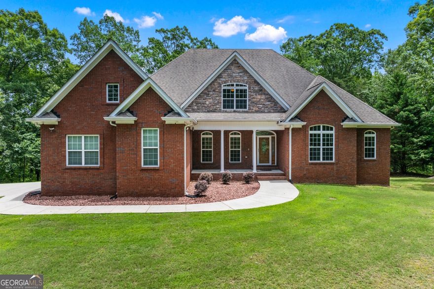 Priced below appraised value. Welcome to Your Dream Retreat in Chattahoochee Hills! Discover timeless craftsmanship and the tranquility of country living in this extraordinary custom-built brick home. Nestled on a private, wooded lot rich with native flora and abundant wildlife, this charming Georgia farmette offers a perfect blend of luxury, function, and natural beauty. Exceptionally maintained and in immaculate move-in condition, this home invites you to simply unpack and start living the lifestyle you've always dreamed of. Thoughtfully designed and built to the highest standards, this spacious residence features five bedrooms and five beautifully appointed bathrooms, providing comfort and flexibility for any lifestyle. At the heart of the home, the chef's kitchen delights with cherry cabinetry, granite countertops, a large walk-in pantry, a cozy sitting area, and a sun-drenched eat-in space. The kitchen flows seamlessly into a four-season sunroom and a generous deck, ideal for grilling, gardening, or simply soaking in the peaceful surroundings. The main-level primary suite is a private sanctuary, complete with dual vanities and a spa-inspired dual-shower system. Upstairs, a versatile retreat offers ideal space for guests, children, or multi-generational living. The fully finished basement is an entertainer's dream, featuring a spacious great room, wood-burning stove, game area, hobby/workshop space, and potential for a full in-law or income-generating suite. Don't miss the hidden safe room cleverly concealed behind a bookshelf in the basement, offering security. Outdoor living is equally impressive, with a large concrete terrace beneath the deck, perfect for hosting gatherings or relaxing beneath the trees. ASK about the additional raised concrete pad tucked away in the woods and not visible from the driveway, perfect for an outbuilding, RV parking, or future expansion. A three-car garage with utility sink, abundant storage, and ultra-fast fiber internet ensures everyday convenience and modern living. Perched on an elevated lot reminiscent of the North Georgia mountains, this home offers daily visits from local wildlife and a sense of peace and privacy. Enjoy direct access to Cochran Mill Park and Bear Creek Nature Center, and an easy 20-minute drive to the airport. Just minutes from Serenby and conveniently located near Newnan, Peachtree City, Douglasville, and Fayetteville, this is more than a home; it is a lifestyle rooted in nature, community, and timeless quality. Schedule your private tour today!