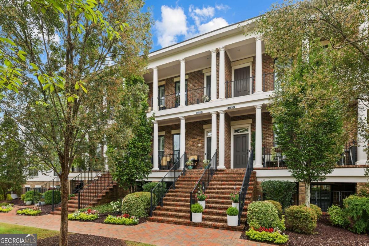 THE BEST LOCATION IN WALKABLE DOWNTOWN ALPHARETTA. Nestled Behind the Green Space on Alpharetta's prettiest tree lined streets with Double Balconies in the heart of Downtown Alpharetta's City Center and Avalon!!. This amazing 3 bedroom townhome has a spacious open floorplan with natural Stone detail around fireplace, hardwood floors, 10'ceilings in the living and kitchen areas and a sunroom great for an office. Kitchen has an abundance of cabinets with soft close doors/drawers, Stainless Steel Appliances, Large island, custom pantry and quartz counters. Large master suite with custom Brick accent wall, balcony for morning coffee, walk in custom closet and an enormous walk in shower with 3 shower heads. ELEVATOR READY! All Closets are custom fitted. as an added bonus the home has ceiling mounted SONOS speakers! Beautifully appointed with Great Space and desirable features making this the perfect move in ready home for empty nesters or downsizers looking for life in the Stroll Zone of all the shops and restaurants downtown Alpharetta has to offer.