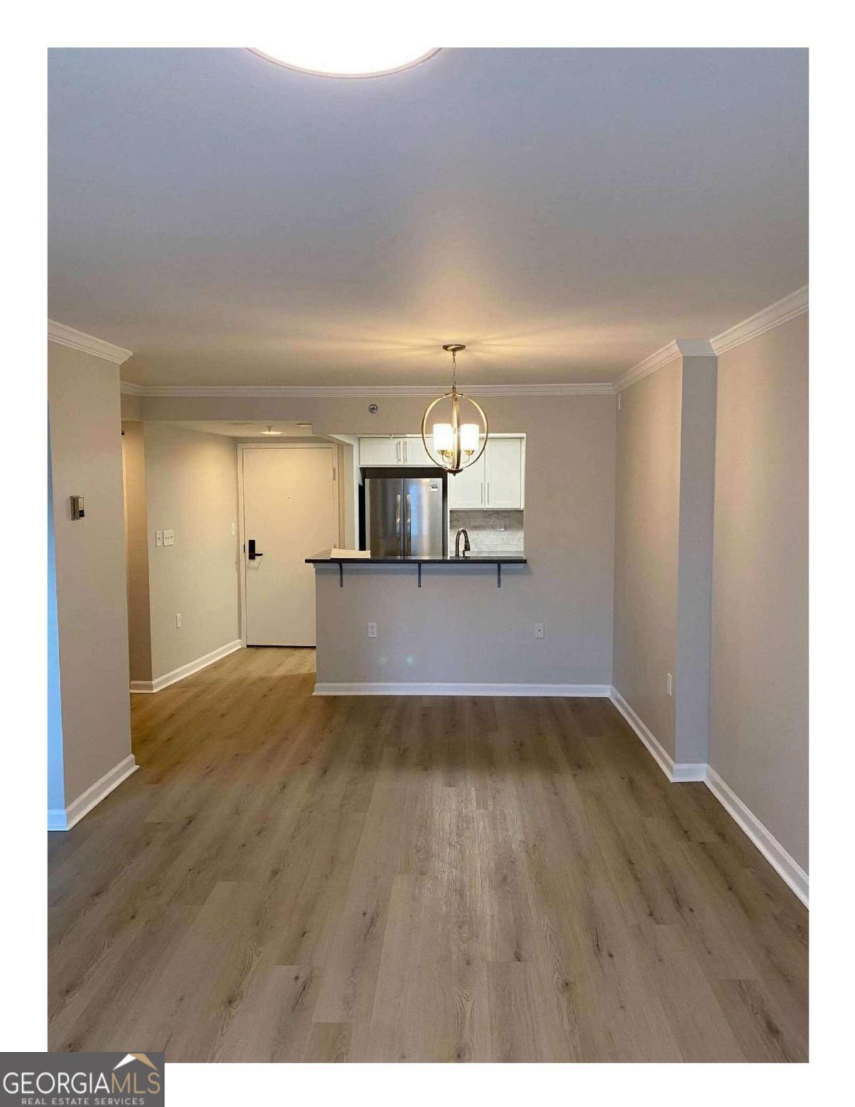 Experience the resort lifestyle at Huntcliff Summit, one of Sandy Springs' premier 55+ independent living communities! This completely renovated one bedroom condo was literally stripped to the studs and rebuilt. As you enter the unit, south facing windows flood the living area with natural light. Turn your attention to the kitchen and behold new cabinetry, quartz countertops, glass tile backsplash, SS appliances, LVP flooring, light fixtures and more! The LVP flooring continues throughout the main living area and bonus room. The main living area leads to a covered, private balcony overlooking a peaceful, tree filled courtyard. The bedroom features new carpet and a generous walk-in closet. The completely remodeled bath features a low- curb, tile shower w/ glass doors for easy access, and a new vanity and fixtures. Just like on a cruise ship, once you leave your 'stateroom' you will find a community tailored to your wants and needs. Indoor heated pool, fitness center, continental breakfast and a full-service restaurant serving lunch and dinner daily, concierge transportation service to shopping, dining, Dr. appts, field trips to cultural attractions, a daily Happy Hour, the list goes on and it's all included in your rent!