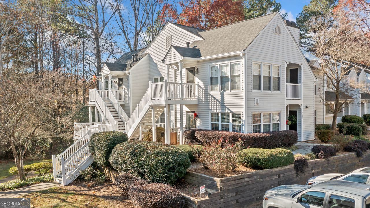 STREET LEVEL. NO STAIRS. Stop wasting your money renting !! You can't beat the location on this cute 1 bedroom condo in popular Cannon Gate. It has has a sunroom/second possible bedroom. Its location in the community is fantastic with wooded views of the common area. Laminate entry foyer, carpet in living areas. The interior includes an open floor plan that provides ample space for comfortable living. The primary bedroom offers a generous layout. Great room has gas log fireplace and views the kitchen via a pass through which is great for entertaining. The galley kitchen has electric stove & cream colored wood cabinets. The dining area/ breakfast nook views the great room. Primary bedroom has walk in closet and laundry. Secondary bedroom can also be used as a sunroom. It has access to a deck and storage room. Bathroom has separate vanity plus bath tub/shower combination and commode in a separate room. Condo fees cover water, sewer, trash pickup, termite bond, exterior maintenance and pool. HVAC and water heater were replaced in 2021 This is in the city of Marietta right off Whitlock Rd and Manning Rd. You can walk to Laurel Park, shops and restaurants. What a great place to live and own instead of renting ! This unit is on the second floor but has stairless entry by entering the front of building L. You just walk around the sidewalk and decking to the unit at the back of the building. Virtually staged.