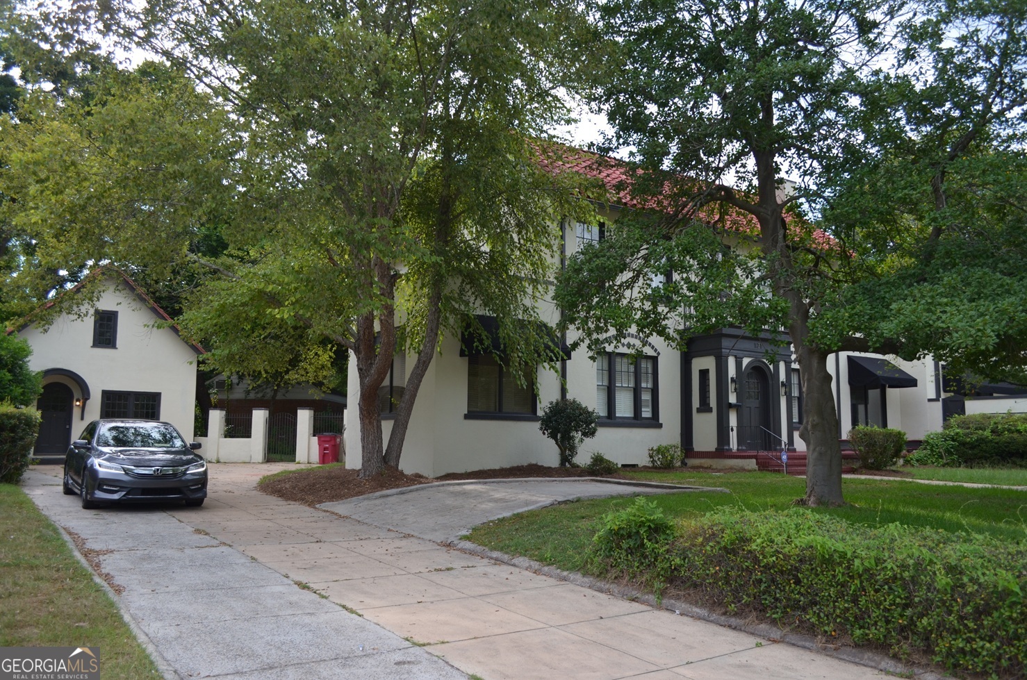 1920's Spanish Colonial home in prestigious Stanislaus neighborhood. Beaming with old world character and charm, this property has been tastefully brought back to its glory days with the right touch of modern convenience and style. Your senses will be captivated and immediately taken back in time as you walk in through the arched front door into the 10' ft high coffered ceilings of your living room. Retreat into your spacious primary bedroom and fix a drink at the wet bar as you head into the lavish en-suite bath for a soak or outside into the privacy of your salt water pool for a dip. Kids will each have access to their own private baths and there's even a guest house for in-laws or rental potential. Too many great things to list about this spacious and one of a kind home. A true Macon gem and a must see!
