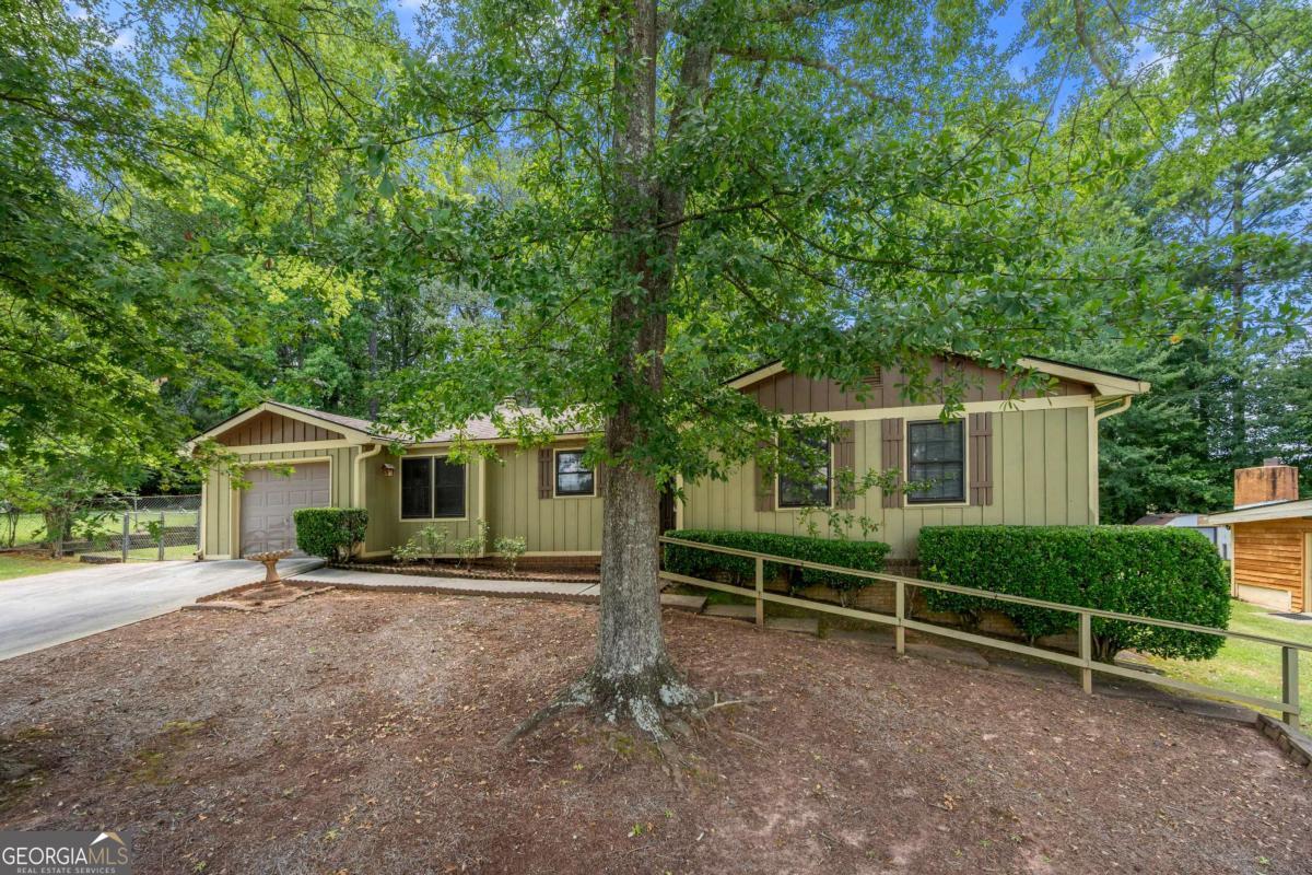 Charming Ranch with Pool on Spacious Lot - Estate Sale Opportunity This 3-bedroom, 2-bath ranch is full of potential and nestled in a tranquil neighborhood on a generous lot. The home features engineered hardwoods throughout and a bright, inviting floor plan. The cozy family room showcases wood-beamed ceilings, rich paneling, and a stunning stone fireplace-perfect for relaxing evenings. The kitchen offers solid wood cabinetry, black appliances, herringbone flooring, and a sunlit eat-in area with ceiling fans. Adjacent to the family room is a beautiful sunroom with abundant natural light, overlooking the backyard and pool area-ideal for entertaining or unwinding. The property includes a one-car garage with an extended driveway, and the pool is currently undergoing maintenance to be restored to its full potential. Additional highlights include a step-in shower, includes washer and dryer, and a peaceful setting with mature landscaping. While the home does need some TLC, it presents an excellent opportunity to customize and make it your own.