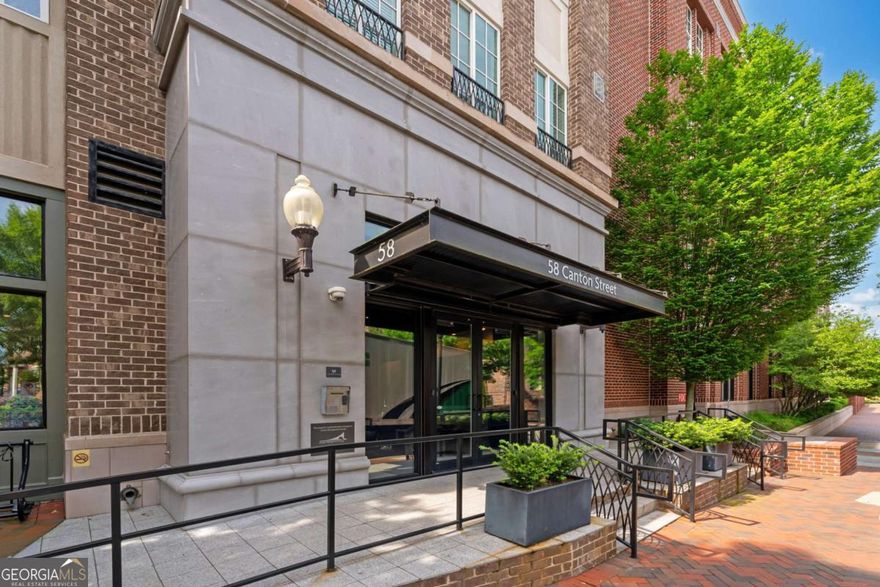 Welcome to Suite 404 at The Alpharetta Lofts - a rare and luxurious 3-bedroom corner unit perched on the top floor of one of the city's most desirable boutique communities. Offering a unique blend of privacy, sophistication, and vibrant city living, this condo is designed for those who appreciate refined details and elevated comfort.    As a coveted corner unit, this home enjoys unmatched panoramic views and exceptional natural light streaming through expansive windows. The professionally curated interior showcases high ceilings, upgraded light fixtures, and exquisite finishes throughout. Beautiful hardwood floors run across the open-concept layout, seamlessly connecting the living, dining, and kitchen areas. The spacious living room features a cozy gas fireplace, creating a warm and elegant focal point.    At the heart of the home is the chef's kitchen, complete with a Wolf 6-burner gas range, Sub-Zero built-in refrigerator, and premium appliances - perfect for gourmet cooking and effortless entertaining. Every space in the unit has been thoughtfully designed for style and comfort, offering an atmosphere of understated luxury.    Located in The Alpharetta Lofts, a private community with only 33 residences across four floors, this building provides 24/7 security and upscale amenities such as a clubhouse, business center, outdoor lounge with firepit, grilling stations, and pet-friendly spaces. The lifestyle here is both serene and convenient, with prime access to all that downtown Alpharetta offers.    Step outside and find yourself in the heart of the city Co just moments from boutique shopping, gourmet dining, lively entertainment, and the Alpha Loop connecting directly to Avalon. Enjoy your morning coffee or quick lunch from Nest Cafe located just downstairs. Whether you're heading out for a walk on the Big Creek Greenway or commuting via GA-400, everything you need is within reach.    Suite 404 at 58 Canton Street is more than a home - it's a lifestyle choice. Perfect for discerning buyers seeking luxury, location, and low-maintenance living in a vibrant and growing community, this property offers the best of urban sophistication and suburban charm.    Experience upscale living in downtown Alpharetta, where comfort meets convenience in the most stylish way.
