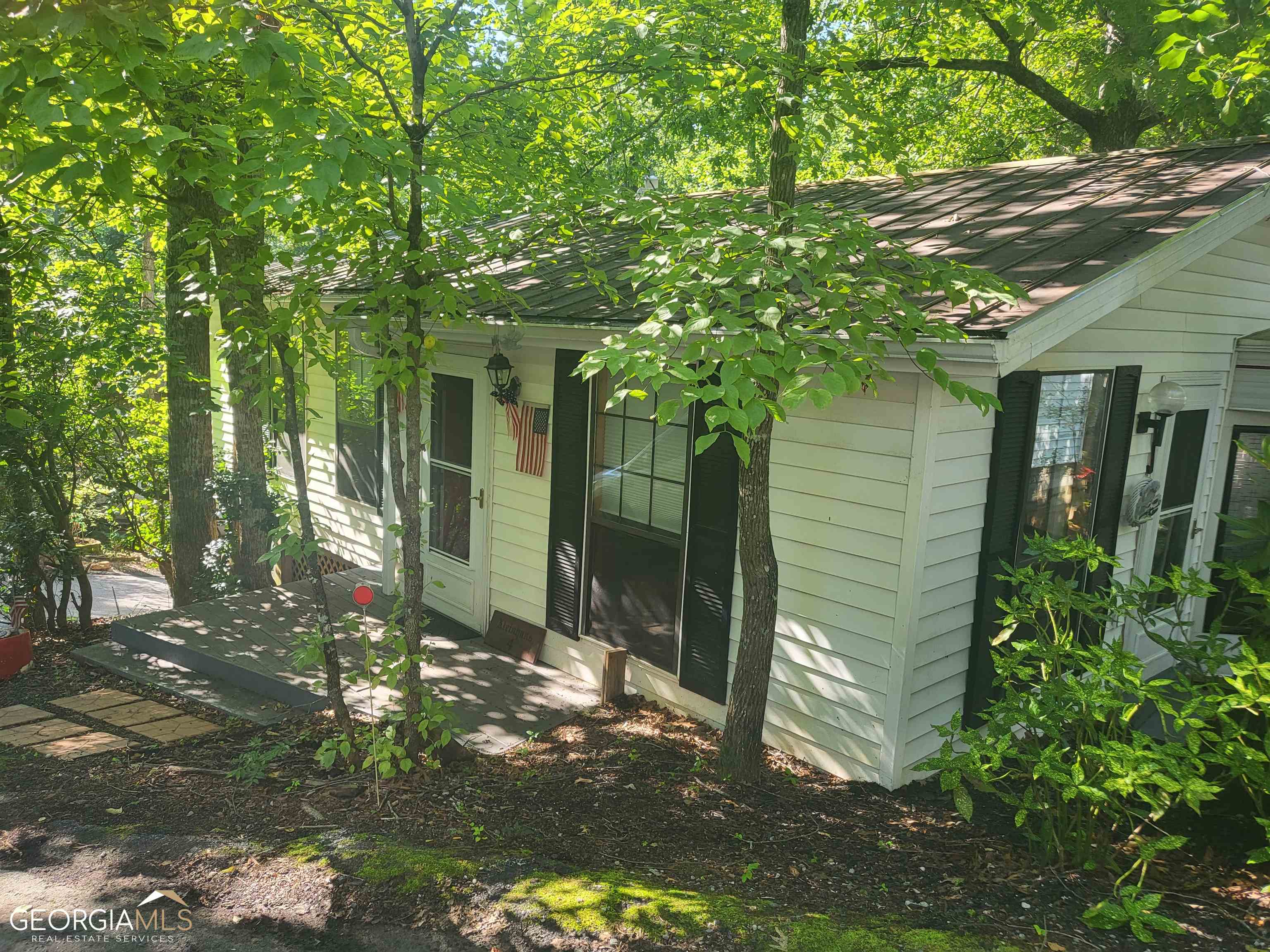 Lots of updates come with this RV with cabin built around it. It offers 2-BD and 2-BA, New Heat pump, all new pex plumbing, large crawlspace access door for easy access. Laundry closet that holds full size washer and dryer. LVP flooring, master bedroom has it's own private bathroom, kitchen is open to the dining area with large bay window. Patio area on the side offers paved parking and a storage building for your toys. The subdivision offers large lake for fishing, canoeing, etc. there is a community building , workout room, gated, guarded security and so much more. This is a vacation or full time property that offers year round amenities. Here is a link for covenants and restrictions https://mountainshadows.us/information.