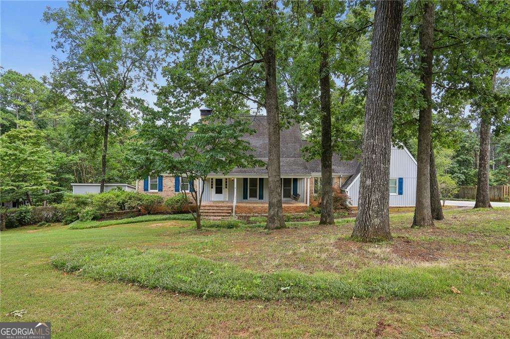 A HOME FOR EVERYONE! Classic Williamsburg-style cape home has three finished levels of a living area, nearly two or more of everything else since it includes a stepless and separate entrance to lower level walkout in-law suite on the property's cul-de-sac side of the lot. Two kitchens, Two fireplaces, Two owner suites! Two Sun rooms (square footage not included in totals) Three hvac systems plus one top floor bonus room unit, Two laundry rooms, Two half baths, Two driveways, Two covered parking areas, ONE Two-car garage for first floor access and a Two-car carport on the corner side for an in-law suite in the walk-out lower level. The home features custom crown molding, new thermal insulated windows, custom colonial Williamsburg wood plank floors with rivets on the main living area and upstairs hallway, beautiful exposed brick walls in the family room and in the kitchen, which features a Jenn-air cooktop with grill. Massive fireplace in the family room. The first of two sunroom enclosures is off the family room on the main floor, and one is for the lower-level in-law suite. Built-in office deck in one 2nd floor bedroom plus lots of built-in shelving in a massive media and rec space on top floor The exterior has Unique Chicago bricks, a flagstone patio, and a waterfall pond with fish. A MUST SEE!