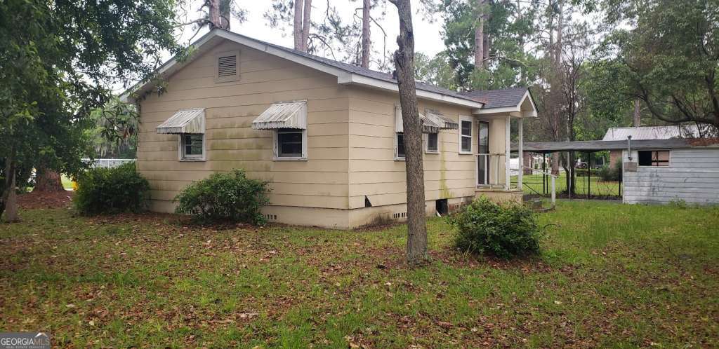 Calling all investors, 1219 Clough St is ready for an owner! This lovely two bedroom, one bathroom fixer-upper is available in Waycross, GA. The property is nested in a large 6,098 Sq. Ft. lot. It features spacious bedrooms, hardwood flooring, a decent sized patio, an outdoor shed/carport, and a good amount of land surrounded by tall trees. This would make an ideal investment for someone looking to renovate a home or a first-time homebuyer in the Waycross area. With the right touches and investments, you and your family will be calling it home-sweet-home in no time! Here you will be directly off the Ossie Davis Pkwy and within a short commute to local parks, supermarkets, and dining. Give us a call today and make this property yours! AS IS.