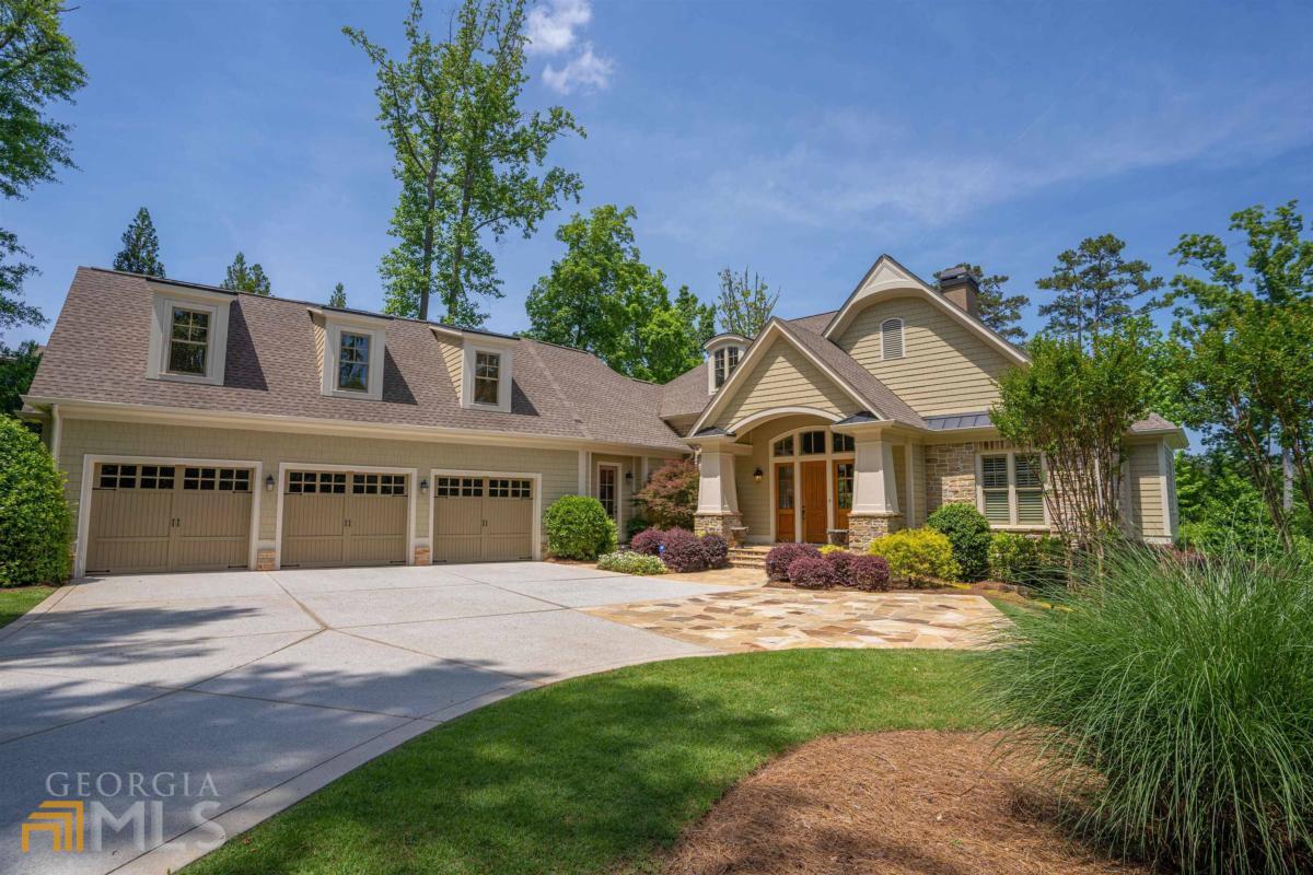 EXQUISITE LAKEFRONT ESTATE IN DESIRABLE SANDY FORD AREA OF REYNOLDS LAKE OCONEE! This custom home has meticulous attention to detail and custom features in every square foot with the highest quality material crafted by builder Jim Joel. Beautifully designed, this dynamic property offers relaxed yet elegant gathering and entertaining spaces. Entering in the front door, you are welcomed with main lake views from the large picturesque windows of the main level great room. Additional details include: custom barrel ceiling in the great room, custom coffered ceilings, large island in kitchen, high end appliances throughout, lakeview keeping room and fireplace, screened in porch and grill deck area. The expansive master bedroom with stunning views of lake and an expansive master bath with separate shower and his and hers closets. On the lower level, there is a gorgeous custom designed wet bar and temperature controlled wine cellar. Three additional bedrooms are located on this level, with easy access to the stone outdoor patio and amenities which include a custom hot tub and pool. The meticulously landscaped yard provides privacy and a resort style feel to the outdoor space. This property is ideally located, close to the Lake Club and Ritz Carlton in the Creek Club area of Reynolds Lake Oconee. This is the ideal lakefront retreat you are looking for! Membership option is available.