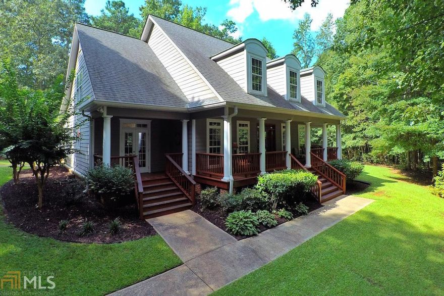 Southern Living Home with lots of style. Outdoor living space is unbelievable. Cover porch with outdoor fireplace and adjoining entertainment area for watching your favorite football team on TV or hosting a cookout or family gathering. MBR and Bath plus 2nd BR/office on main level. Generous sized great room with wood burning FP. Kitchen with large dining area. Upstairs has 2BR's and 3rd bath plus walk-in attic area ready to be finished for more living area. Front porch, 2 almost 2 acre lot with detached garage.