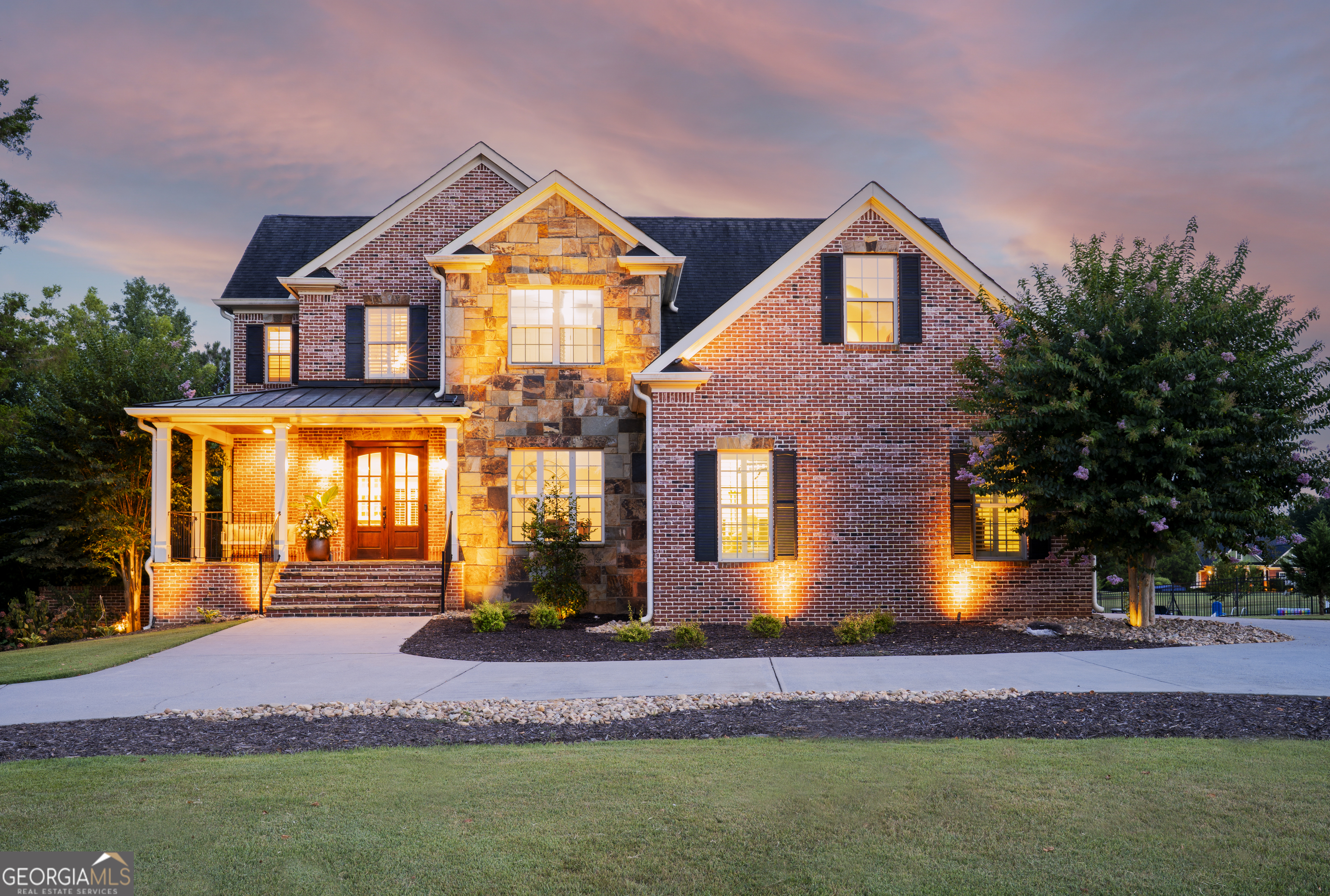 Private luxury retreat nestled on a 1.45 acre level, manicured lot with a stocked pond. This stunning four-sided brick estate showcases an elegant circular drive and a 4-car garage, offering both curb appeal and an abundance of parking. Inside, a grand foyer leads to a formal dining room with custom trim. The heart of the home is an exquisite island kitchen featuring quartz countertops, a pot filler, ceiling-high custom cabinetry with wood and glass doors, a built-in refrigerator, coffee bar, and top-tier stainless appliances - all open to a spacious fireside family room. Hardwood floors run throughout the home, including the luxurious primary suite with a spa-inspired bath, soaking tub, dual vanities, and spacious walk-in closet. The family room leads to a covered back porch overlooking the pool area and offers a grilling deck. Upstairs, two generously sized secondary bedrooms offer private en-suite baths, the third bedroom has access to the baths. The finished terrace level offers a full in-law or teen suite with its own entrance, complete with a fireside bedroom, full 2nd kitchen, family room, gym/flex garage, walk-in closet, full bath, and covered back porch - the perfect multi-generational/teen setup. Enjoy resort-style outdoor living with a heated in-ground pool, flagstone patio, wrought iron fencing, and a covered poolside fireplace lounge - ideal for year-round entertaining. Detached garage offers a dedicated office upstairs, perfect for remote work. Luxury, comfort, and space await. Call today to see this gorgeous home.