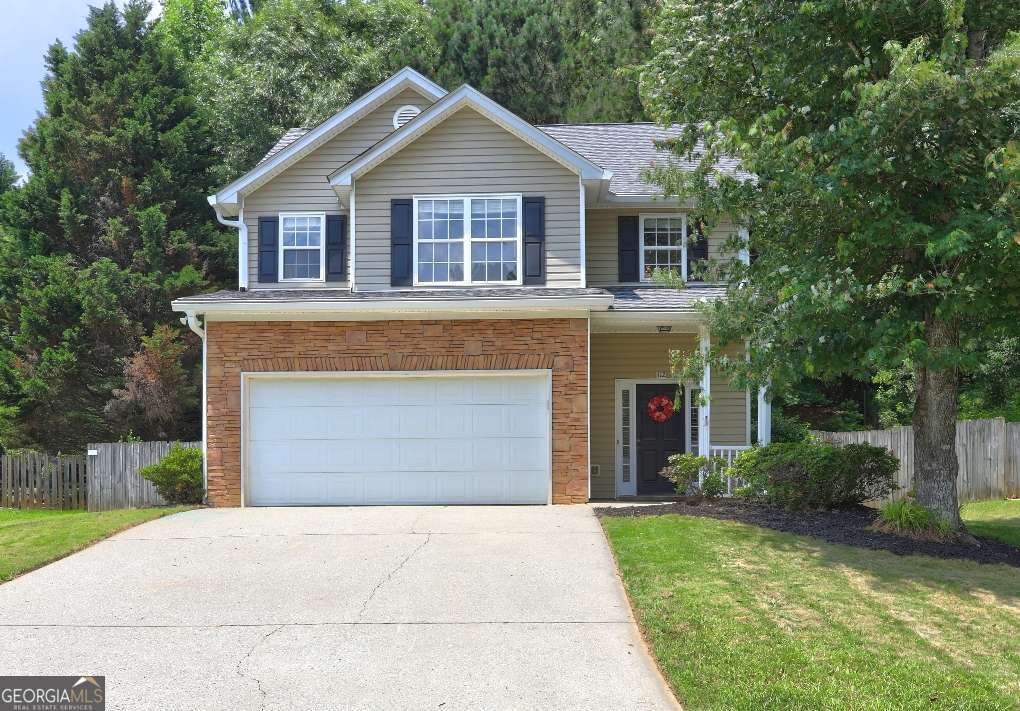 Welcome home to this great open floor plan walking distance from Woofstock Dog Park with access to Noonday Creek Trail and 1.25 miles away from Downtown Woodstock! This four bedroom, two and half bath home includes a hardwood living room w/ marble gas fireplace, spacious kitchen with a large breakfast area and a view to the living room. Master suite w/ trey ceiling, garden Jacuzzi tub, double vanity and separate shower. Upstairs laundry room, rocking chair front porch, private fenced backyard. Maintenance free vinyl siding and NO HOA! Excellent schools and location - minutes away to I575 and Highway 92!!