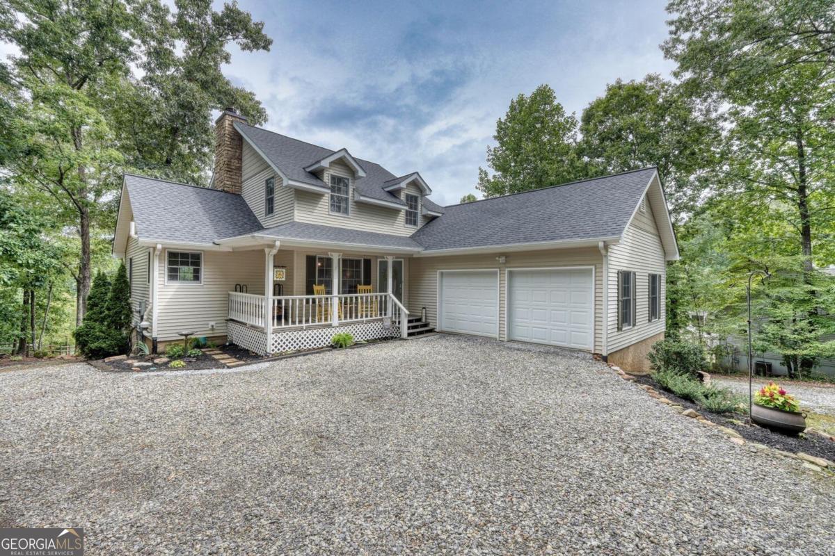 Dream Retreat on Lake Nottely! Nestled in a tranquil cove on the shores of Lake Nottely, this charming lake home offers the perfect blend of comfort & natural beauty. This stunning property features a gentle slope to the water, and offers easy access to for all your favorite water activities. Spacious 4br/3.5ba provides ample space , ensuring everyone has a place to relax & unwind. Home is ideal for entertaining with a floor plan that flows effortlessly onto a large deck overlooking the lake, which is perfect for gatherings or enjoying leisurely evenings by the lake and/or morning coffee. It is in a quiet neighborhood with mostly all paved access, walkable streets for evening strolls or morning runs in a friendly community. Experience peaceful waterfront living, with wonderful lake views & a serene setting for rejuvenation & recreation. Special features include a brand new roof & new kitchen countertops, meticulously maintained, wood burning stone fireplace, two c/h/a units, access to large deck from kitchen, living room & master bedroom, 2-car garage, large finished basement with bar & pool table, fire-pit area by the lake, perfect cove to float around in without all the wake, high-speed internet, lots of parking & makes a great rental too! Don't miss this opportunity to own a stunning lake home in the breathtaking North GA Mountains!