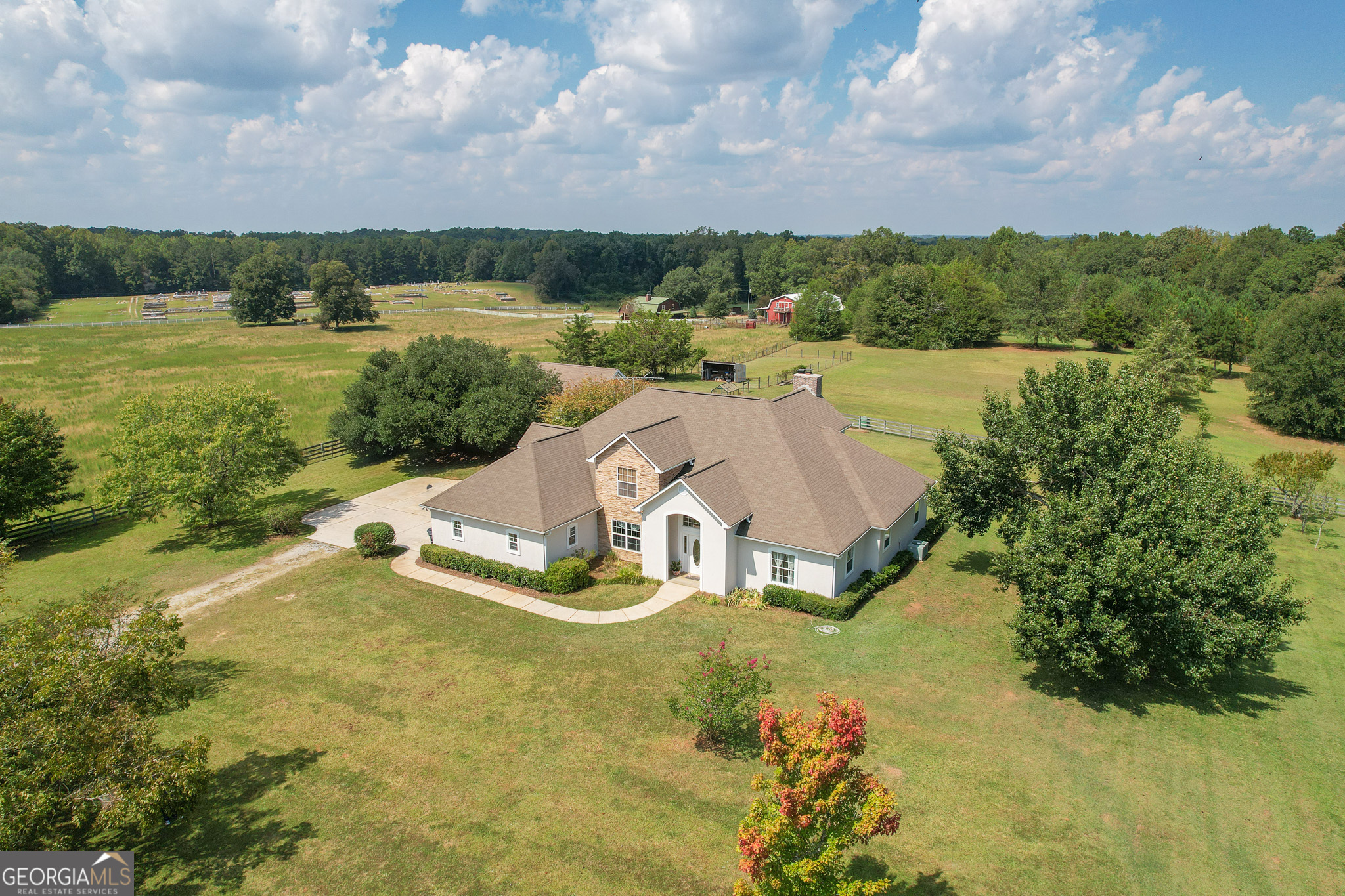 Welcome to this stunning Pike County home, offering over 3,700 square feet of living space on more than five acres of peaceful countryside. Thoughtfully designed with comfort and functionality in mind, this residence is full of timeless character. Inside, you'll find five spacious bedrooms and three full bathrooms, including a large master suite with a beautifully organized walk-in closet. The heart of the home features a country-style kitchen with quartz countertops, a central island, and plenty of storage, opening into warm living spaces accented by oak hardwood floors and two brick wood-burning fireplaces. Outdoors, enjoy the perfect balance of relaxation and entertainment. The backyard boasts a 600-square-foot powered building, ideal for a workshop, office, or hobby space, along with a charming patio and hot tub for gatherings. Every level of this home offers sweeping country views, making it a true retreat. A two-car garage provides convenience and additional storage. Listed below appraised value, this property is a rare opportunity to own a spacious, private home in one of Pike County's most desirable settings