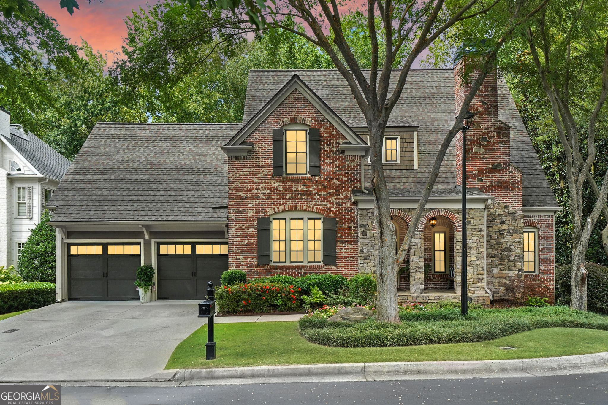 Wow! Don't miss the opportunity to make this move-in-ready 5 bedroom, 3.5 bath craftsman/traditional home in the desirable private gated Alpharetta community of Woodvale your own! This fabulous primary-on-main, 4-sided brick and stone home features gleaming hardwoods, luxurious 10 ft ceilings and open-concept floor plan on the main level, and custom finishes throughout! The main living level includes a separate formal dining room- perfect for a home office, spacious eat-in kitchen complete with custom cabinetry, stone countertops, stainless appliances, and adjacent breakfast area, all open to the striking two-story vaulted fireside family room that overlooks the lush tree canopy of the backyard! Additionally on the main level, you'll find the oversized primary bedroom with gorgeous cozy fireplace, large walk-in closet, and beautiful ensuite bath with double vanity, walk-in shower, and separate jetted tub. Upstairs, you'll find four sizable guest bedrooms- one that could be used as an additional primary suite, as well as two guest bathrooms. The partially finished walk-out daylight terrace level offers a large multi-purpose space and is stubbed for bath- ready to create a fantastic private guest suite if desired! Outside, you'll find two convenient decks off of the main level- one covered and perfect for grilling or just relaxing in the shade, and the other uncovered, great for soaking up the sun! The peaceful tree-lined backyard also includes a fire pit area and creek that runs through the property with a charming bridge connecting the rest of the yard. Private pond shared by HOA and Church is a quiet little retreat to take walks. Woodvale is located just minutes from the Big Creek Greenway, Newtown Park, grocery stores, restaurants, and more! DON'T WAIT, be sure to schedule your showings ASAP!