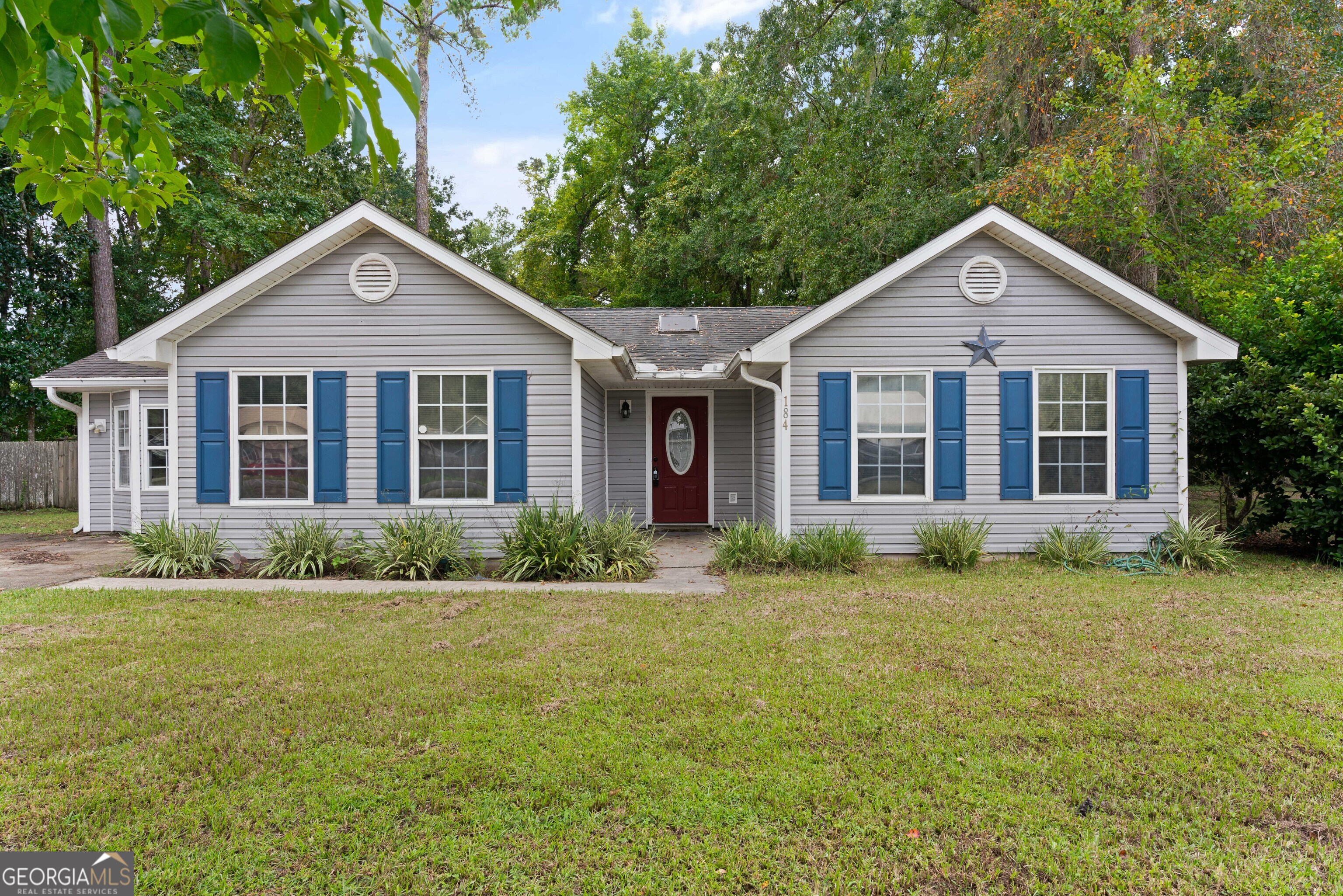 This 4 bedroom/2 bath home is not in an HOA or flood zone and is conveniently located just minutes from I-95 and Kings Bay Naval Base. It boasts a split floor plan with a spacious great room leading to newly installed sliding glass doors that open up to a screened porch. Wood-look tile flooring extends throughout the property. The kitchen comes equipped with stainless steel appliances, including a recently replaced dishwasher, refrigerator, and vent hood, as well as granite countertops with a breakfast bar. The combined pantry/laundry room includes a washer, dryer, and floating shelves. The master bedroom offers an updated tiled shower and wood shelving in the closet. The large backyard is fully fenced, providing privacy and space. Additionally, there is a separate garage/workshop that will appeal to many. Act quickly on this desirable property!