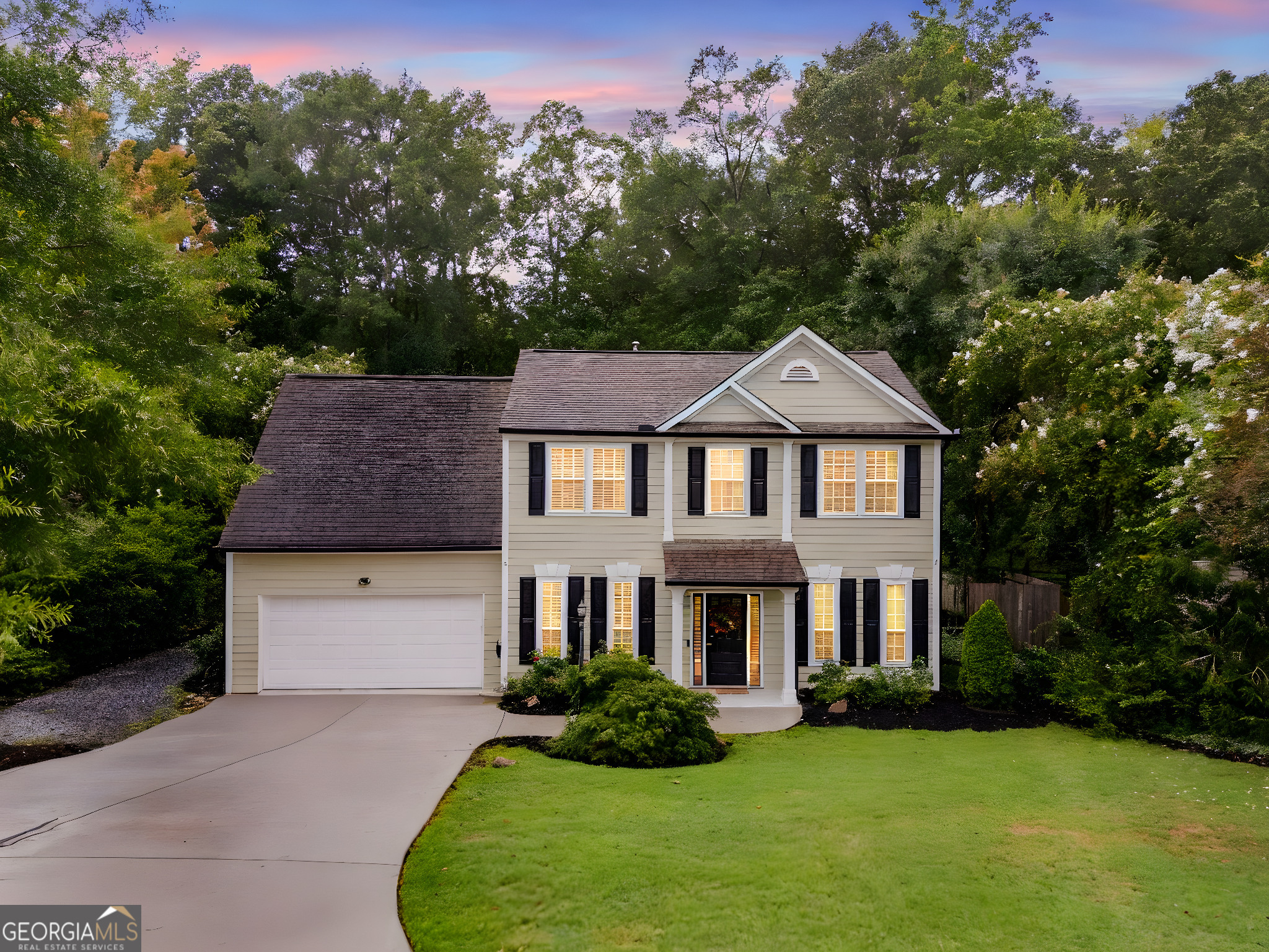 Love the traditional curb appeal, but not a traditional floorplan? This home will WOW you with almost 3,300 sq ft, a spacious, open floorplan with a freshly painted interior, 5 bedrooms, including a large bedroom suite on the main level, 3 full bathrooms, and a 1/2 bath for guests. This home loves gatherings with friends & family! As you enter, you'll find a study/office and a dining room with chair rail, open to a beautifully updated kitchen with soapstone countertops, stainless steel appliances, extensive cabinetry with pull out shelving and soft close doors & deep drawers, built-ins, a tile backsplash, pendant lighting, dry bar, and extended, marble-topped island with pendant lights, fronting to a spacious keeping room with a beamed/coffered ceiling. The adjacent family room features hardwood floors, high ceiling with wainscotting and recessed lighting, a pretty, boxed recess with floor to ceilings windows, and loads of natural light. Off the family room, you'll find the first bedroom with an impressive, barrel ceiling, fan, tiled flooring, walk-in closet, and an elegant ensuite bathroom. A laundry room, powder room, and two-car garage complete the main level. Upstairs, retreat to the rest of the bedrooms, including the primary suite dressed with extensive crown moulding, deep trey ceiling, fan, walk-in closet, and ensuite bathroom with double vanity, soaking tub, and separate shower. The secondary bedrooms will delight as well - one features a built-in bunk, one a game room AND bonus space, and one has a dreamy ceiling of clouds. All have ceiling fans. The secondary bathroom offers tiled flooring, a double vanity, and shower. The backyard is made for fun and relaxing gatherings, too. The side courtyard patio is perfect for outdoor dining and leads down to a large firepit flanked by large stones. Imagine having your own basketball court! And a workshop! All this and still plenty of room to play. The neighborhood provides a swimming pool and community lake with a fishing dock. Perfect location with reputable schools and a short drive to shopping, restaurants, and parks.