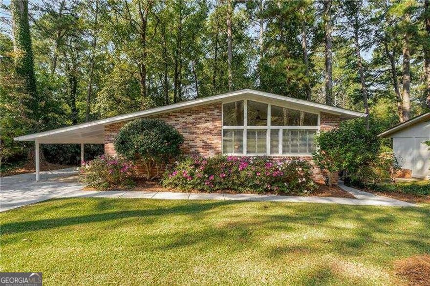 Check out the virtual 3d tour. This spacious and immaculate 3 bed 1 bath home features gleaming hardwood floors throughout, a light filled living room that has vaulted ceilings and opens to the dining room. Enjoy cooking in the updated kitchen featuring white cabinetry, granite countertops, stainless appliances, and easy access to the carport for bringing in groceries. One of the three bedrooms will make for the perfect office/den space. Spacious laundry room includes washer & dryer which stay with the property. Venture outdoors to see the huge private fenced yard, and the new deck makes for the perfect outdoor experience. The one-car carport and parking pad have plenty of parking for multiple cars. All appliances remain including the washer and dryer. Convenient to Emory/CDC/CHOA, as well as Downtown Decatur, Toco Hill Shopping, and major roads.