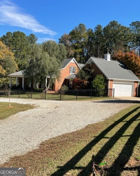 This 4-sided brick home sits on 8.3 acres, and is located only 4 minutes from Trilith Studios, 20 min to Airport and about 35 min to downtown Atlanta. Privacy galore, gated, secluded. Master on main, 2 bedrooms and large bonus up which could be 4th bedroom. Spacious sunroom overlooking 20X40 salt water pool. Brand new 40X60 barn with tons of storage so you won't need to store anything elsewhere. Fenced yards. Ideal for home offices or families that home school. Home has been updated. Plenty of room to park campers, trailers, or equipment. . No livestock, but dogs OK. Call Kristen Walker 678-215-1179 today for a showing appointment. Available NOW!