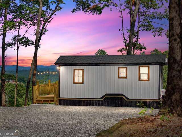 Turnkey Short-Term Rental with Stunning Mountain Views & Proven Passive Income! Don't miss this rare opportunity to own a highly-rated, fully furnished short-term rental with a consistent track record of bookings and rave guest reviews. This charming tiny home sits on a private acre with unobstructed 180-degree views of the beautiful Blue Ridge Mountains-perfect for relaxing getaways or income-generating investment. Guests love the spacious deck featuring a grill, cafe lights, fire pit, and peaceful stargazing. Inside, you'll find a cozy, thoughtfully designed space with an electric fireplace, sleeping for 3-4, and a kitchen equipped with everything you need-including a refrigerator, microwave, and icemaker. Whether you're expanding your portfolio or seeking a mountain retreat of your own, this property is ready to perform from day one. No HOA, strong rental history, and minutes to hiking, wineries, and charming mountain towns!