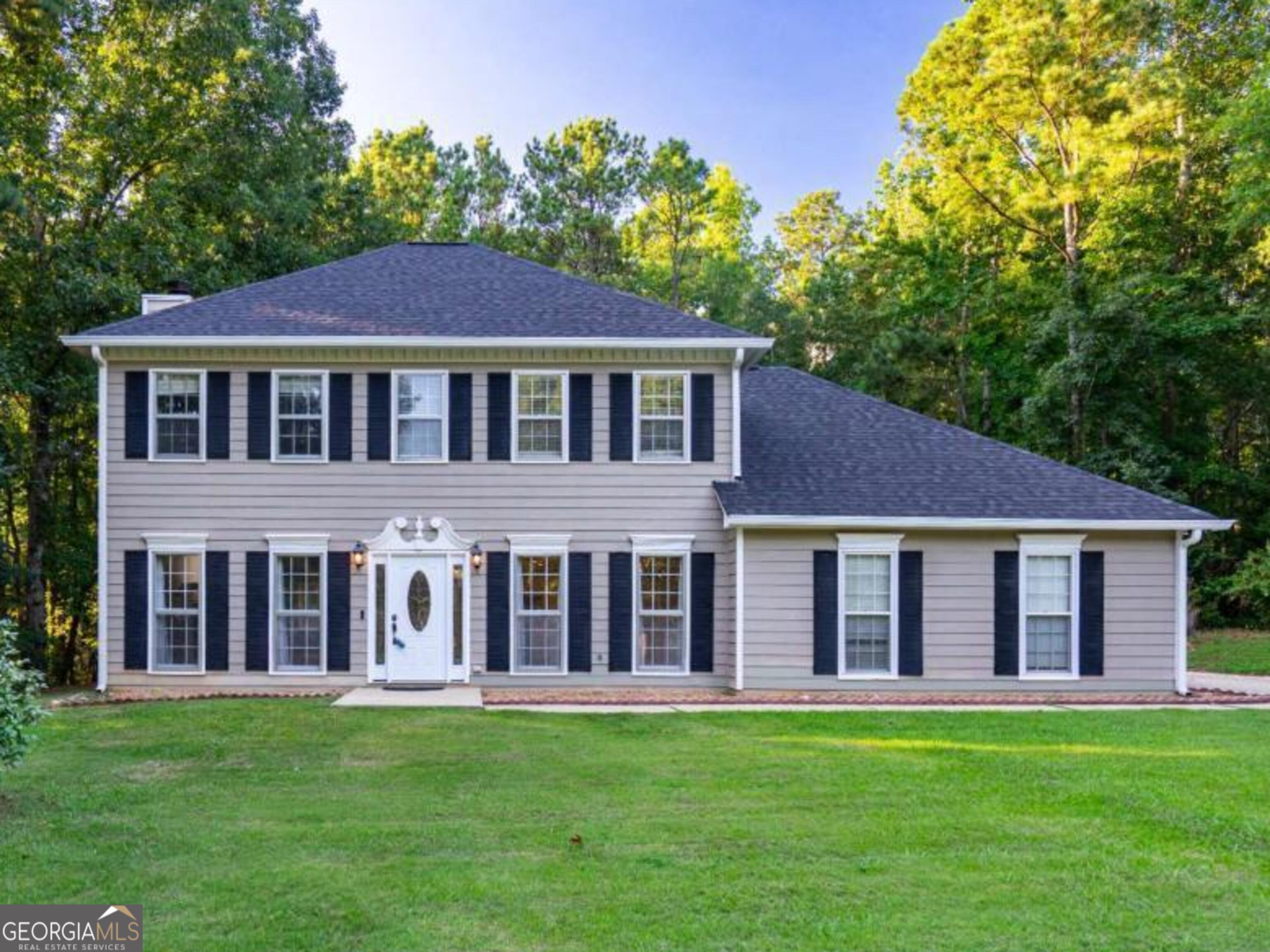 Welcome to Heritage Hills! This beautiful and spacious 3-bedroom, 2.5 bath colonial-style home offers curb appeal, timeless style, and all the benefits of living in a swim community, complete with a large, private backyard retreat. Step inside the front door, where a classic staircase greets you alongside a spacious Great Room. Anchored by a wood-burning fireplace with a decorative mantle, it's easy to imagine stockings hung there in just a few months. Hardwood floors, crown molding, and French doors add charm, while natural light fills the space and invited you into two versatile bonus rooms, perfect for a home office, playroom, exercise space, or even a potential fourth bedroom. Just off the Great Room, you'll find a freshly updated Powder Room with new vanity, toilet, and linen closet, along with a handy under-stair storage nook. From there, the home opens into a generous Kitchen that truly is the heart of the home. The wall between the Kitchen and Dining Room has been opened to create an airy, open concept feel, complete with a large island, stainless steel appliances, recessed lighting, and plenty of counter space. A cozy Breakfast Room with bay window provides the perfect spot for casual meals and connects you to both the two-car garage and the laundry room. The laundry room is thoughtfully designed with built-in cabinets and an oversized drop zone for shoes, bags, and more. From here, you'll also find an expansive walk-in pantry with custom shelving, ideal for keeping everything organized. French doors off the Great Room lead to one of two light-filled bonus rooms, with the second featuring an exterior door to the massive back deck. Freshly painted and offering built-in seating, this deck is made for entertaining, plenty of space for grilling, outdoor dining or simply relaxing while overlooking your private backyard oasis. A walking trail leads to the rear of the property where you'll find a storage building with lean-to, perfect for lawn equipment, ATVs, or gardening tools. Upstairs, two spacious guest bedrooms share a hall bath with shower/tub combo, while the owner's suite provides a true retreat. The expansive bedroom features dual walk-in closets with custom shelving, and a beautifully remodeled bath with farmhouse lighting, shiplap accent wall, double vanity, and a stunning custom concrete shower. Additional highlights include: two EV charging stations in the garage, new garage door and motor, new gutters and downspouts, new dishwasher, two HVAC units (Carrier system just 2 years old with new ductwork), Blink home security with 8 cameras and video doorbell, EECO whole-home mesh Wi-Fi, and a roof replaced in 2020. Sellers have also completed some fresh paint, new flooring in the bonus rooms, professional carpet cleaning, and exterior soft washing and pressure washing, making this home move-in ready. Just a short distance from the neighborhood pool and complete with a transferable termite bond, this home is the perfect mix of comfort, upgrades, and community living. Schedule your appointment and let's get you moved in time to enjoy hosting those football parties on that back deck or holiday gatherings that are coming up soon!