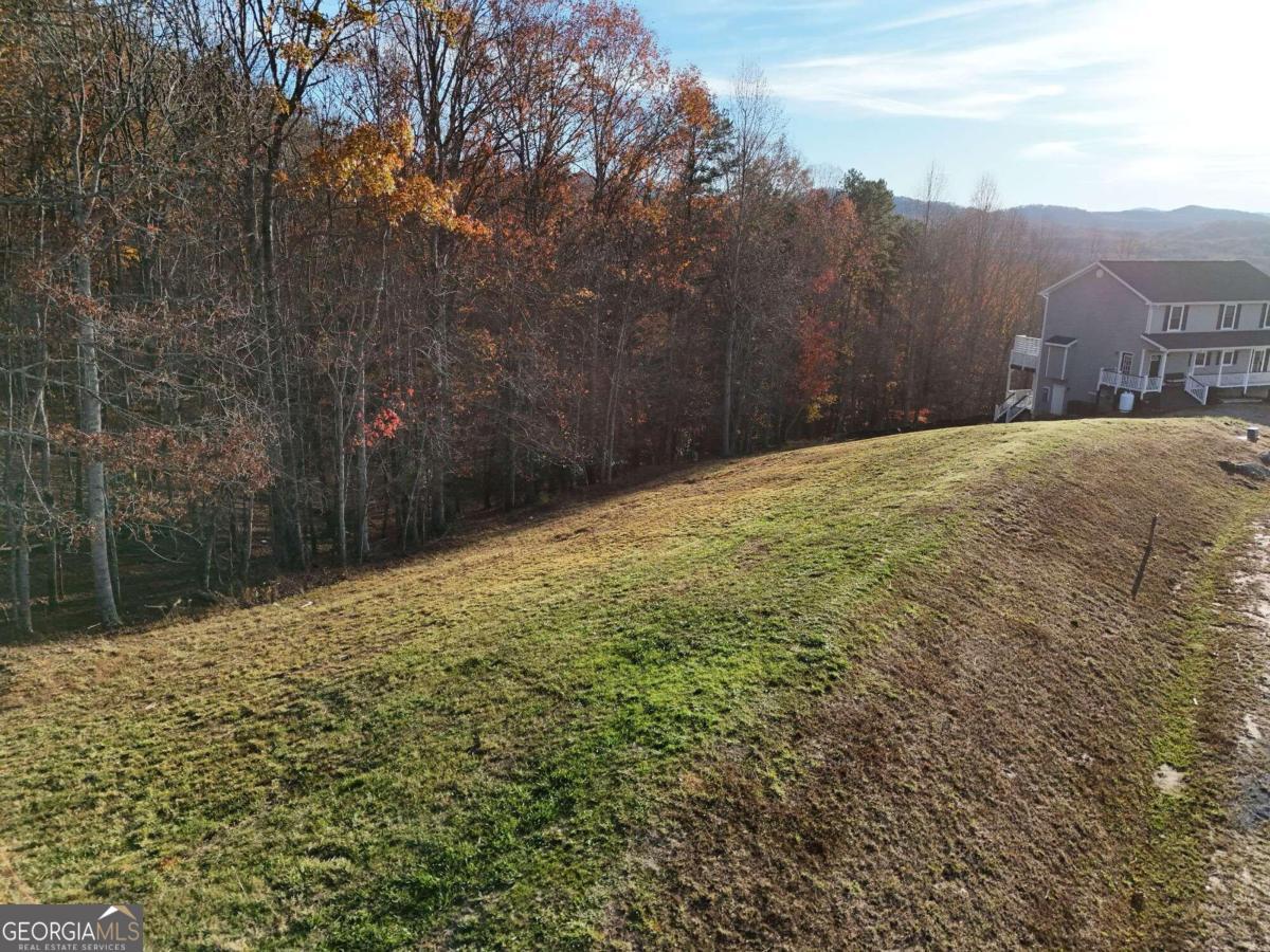 ALL OFFERS ARE BEING CONSIDERED, MOTIVATED SELLER....Nestled in the heart of nature's beauty, Lot 37 offers an ideal canvas for your dream home. Imagine your future residence perched on this lush lot, providing breathtaking long-range valley views of the majestic Blue Ridge Mountains. With gentle slopes and panoramic vistas, you'll enjoy the daily spectacle of vibrant sunrises and serene sunsets. Big Valley is not only a haven of tranquility but also offers convenience with its proximity to both sought after towns Blairsville and Blue Ridge. The lot is equipped with underground utilities and community water, making it a prime choice for your new home. Don't miss out on the chance to build your dream retreat in this exquisite setting. The survey and soil work have already been completed, ensuring a smooth path to creating your perfect sanctuary. Embrace the lifestyle you've always envisioned in Big Valley!
