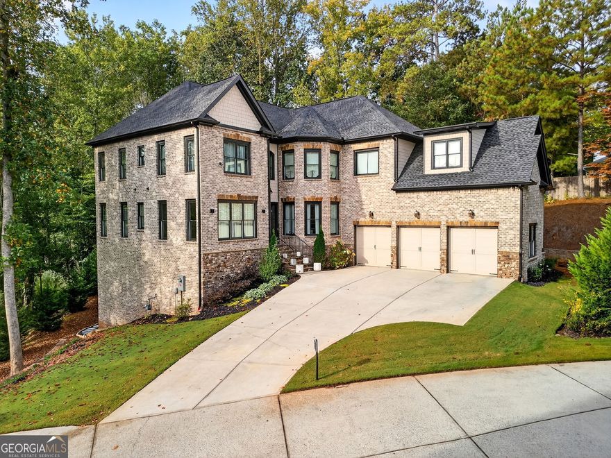 Welcome to this stunning custom residence where thoughtful design and timeless luxury meet. At the heart of the home is a chef's dream kitchen featuring a smart Jenn-Air oven controllable from your phone, seamlessly integrated Thermador refrigerator and dishwasher, a beverage refrigerator, and a microwave drawer. The oversized quartzite island, raised for comfort and crafted with a sophisticated mitered edge, serves as both a designer showpiece and the hub for gatherings. High-end Brizo fixtures, true wood floating shelves, and a seamless connection to the family room complete this exceptional space. Every detail of the home has been elevated, from 8-foot doors on the main level to the striking double-sided limestone fireplace that anchors the living areas. The powder room features a custom vanity with a six-inch miter edge, designed to impress with its statement-making style. The primary suite offers a private retreat with a generous seating area, custom His & Her closets, and a dream-worthy closet complete with a six-foot island and a dedicated lounge for journaling or makeup. The spa-inspired bath includes an oversized Kohler soaking tub framed by floating shelves and natural sunlight, a steam shower with bench and cubby storage, and a 60-inch vanity with elegant detailing. Gold Brizo fixtures throughout add a touch of daily indulgence. Additional highlights include a beautifully appointed Jack & Jill bathroom with floor-to-ceiling tile, a custom powder room vanity, and luxury finishes that set this home apart. This property is more than a home-it's a lifestyle, offering sophistication, comfort, and thoughtful design at every turn.