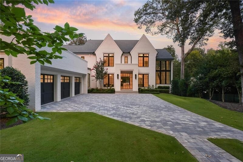 Welcome to your dream home in the heart of historic Tuxedo Park, Atlanta's most prestigious neighborhood. This luxurious new construction residence built by Stokesman Luxury Homes offers unparalleled elegance and sophistication, with every detail meticulously crafted to exceed your expectations. Step inside this masterpiece and be greeted by exquisite craftsmanship and timeless design. The grand foyer sets the tone with its soaring ceilings and radiant natural light, welcoming you into a world of luxury. The main level boasts an open-concept floor plan, perfect for entertaining on any scale. Your eyes will be immediately drawn to the spectacular iron window wall in the rear which leads you to the large covered veranda with outdoor kitchen and unmatched wooded views. The gourmet chef's kitchen features top-of-the-line appliances, custom cabinetry, catering kitchen, butler's pantry, and a spacious island with seating. Adjacent is a formal dining room, ideal for hosting memorable dinner parties. Relax and unwind in your opulent living room, adorned with a fireplace and designer finishes throughout. Stunning iron and clad doors/windows throughout offer picturesque views of the lush surroundings, creating a serene ambiance. Flat walk out lawn with exceptional privacy and plenty of room for a future pool and cabana. Two spectacular owner suites that are romantic and breathtaking including one on the main level. Retreat to the upper level, where indulgence awaits in the sumptuous owner's suite. This sanctuary boasts a large and private exterior sitting area, spa-like ensuite bathroom, and separate expansive customizable walk-in closets. Three spacious secondary bedrooms offer comfort and privacy for family and guests, each with its own ensuite bathroom and customizable walk-in closet. The unfinished basement presents a blank canvas, allowing you to customize and create the ultimate recreational space, home theater, or gym to suit your lifestyle. Comprehensive 2-10 Warranty included for worry-free living. Be prepared to fall in love!