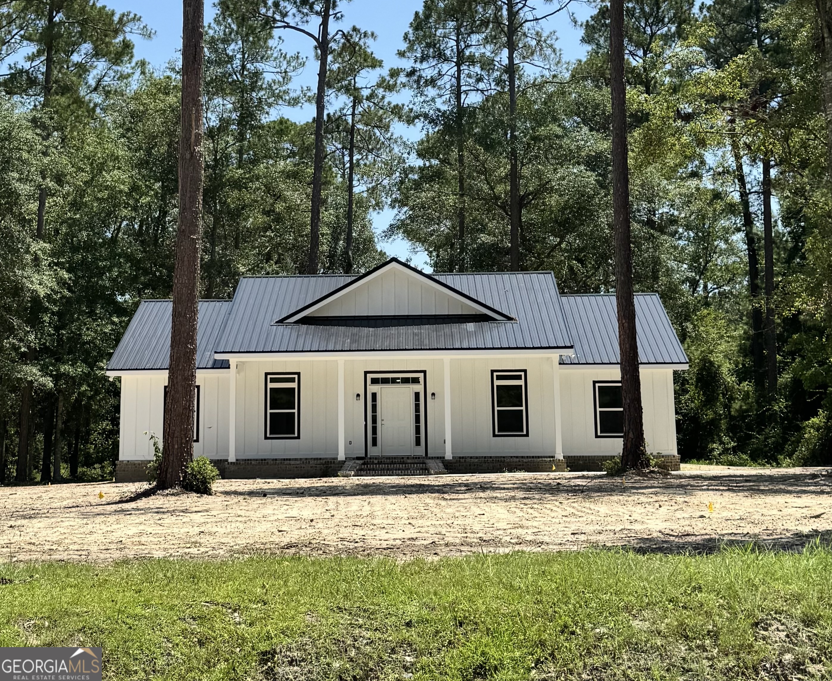 Custom New Construction Home in Claxton, GA! Step into this beautifully crafted new construction home where every detail has been thoughtfully designed. Featuring an open-concept floor plan that seamlessly connects the living, dining, and kitchen areas, this home is perfect for both entertaining and everyday living. The layout includes two spacious bedrooms and a full bath on one side, and a serene master suite on the other. The master bath is a true retreat, complete with a luxurious soaking tub, a walk-in tiled shower, double vanities, and a generous walk-in closet. The kitchen is a chef's dream with stainless steel appliances, sleek granite countertops, and ample cabinetry. Oversized windows in the living area flood the space with natural light, creating a warm and inviting atmosphere. Exterior features include durable hardboard siding, a tankless gas water heater, sprinkler system and a Generac home generator (to be installed soon). The double carport opens to a covered back porch-perfect for relaxing or entertaining outdoors. The yard has been freshly seeded with grass, and landscaping is on the way. Conveniently located just minutes from Pinewood Christian Academy, approximately 10 miles from I-16, and only 40 minutes from the Hyundai Mega Plant. This showcase home truly has it all-don't miss your chance to make it yours! Call Michelle today to schedule your private showing: 912-213-0316