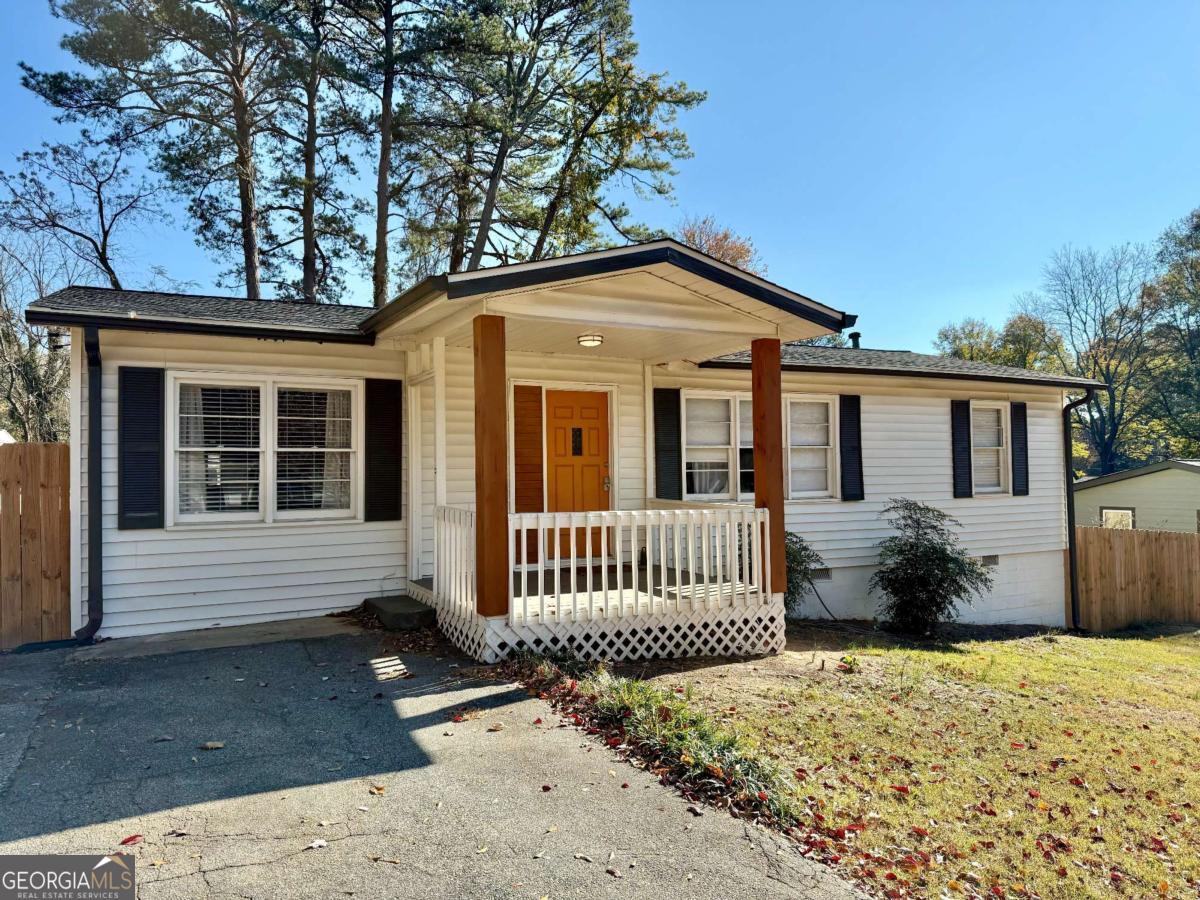 Perfectly renovated 4 bedroom/ 2 bathroom ranch- convenient for single-level living and move-in ready! NEW ROOF with new insulation in 2023, full kitchen renovation with white cabinets, granite countertops, stainless steel appliances, AND a brand new sewer line. The AC condenser unit was replaced in 2019. This home features an open floorplan living room with refinished hardwood floors throughout. The primary suite is tucked away with a built-in bookshelf and ensuite bathroom. 2 more bedrooms plus an office/ bonus room are separated on the far side of the house with an updated bathroom to share. Like a brand new home, but with all the charm of a mid century ranch! Head out to the cozy back patio with views of your expansive level, fully-fenced backyard. Perfect for entertaining friends on a crisp fall night. The laundry closet off of kitchen area comes complete with washer and dryer. Convenient to I-285, I-75, and Atlanta Rd, this location is just a short drive to The Battery, Cumberland Mall, Smyrna Market Village, & tons of shops and restaurants.