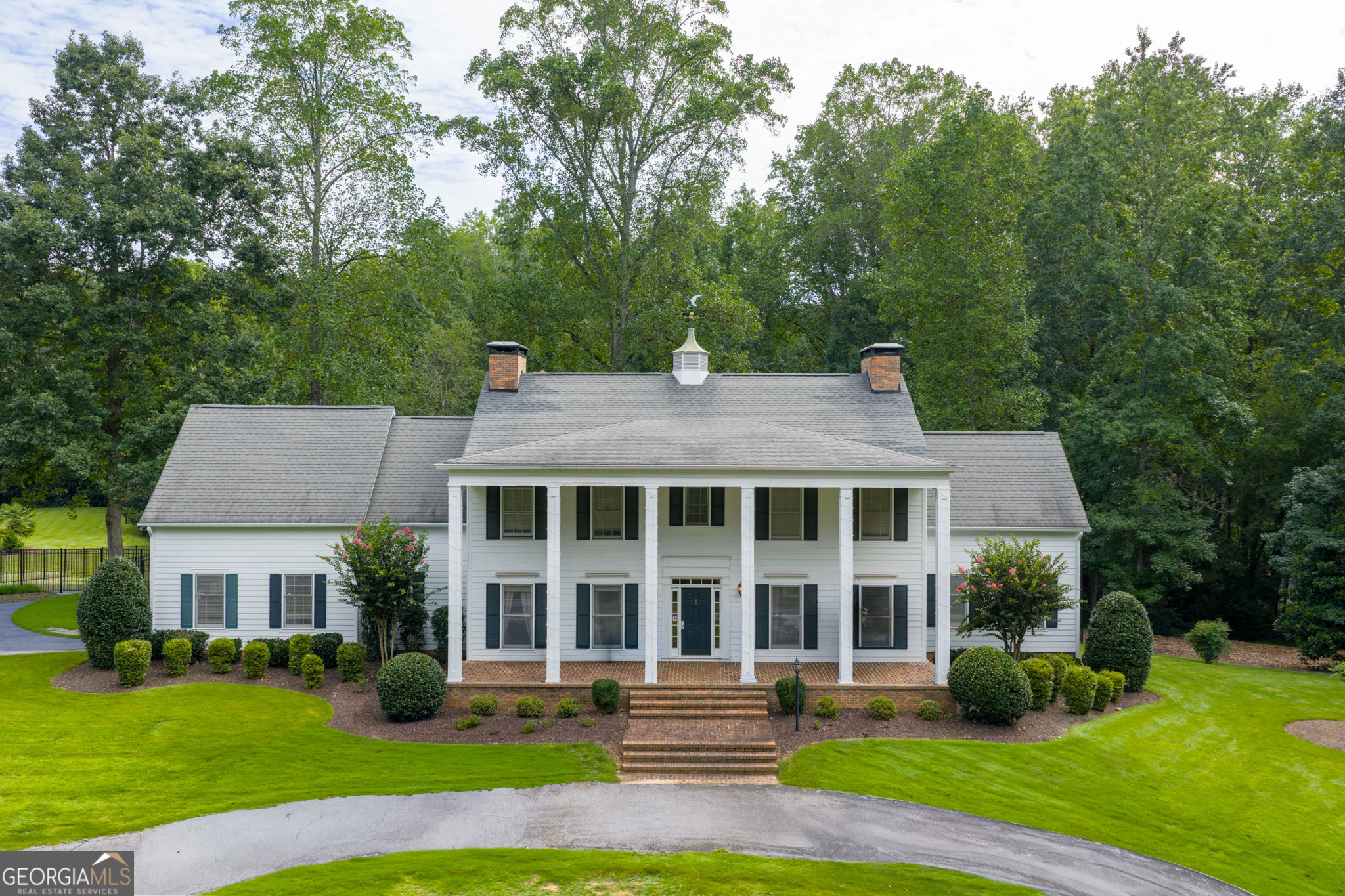 Coming Soon on September 15, 2025, in the heart of Peachtree City! This Southern Manor, set on 2.4 acres and reminiscent of the timeless elegance of Gone with the Wind, is being lovingly prepared for market. Stately two-story columns and a sweeping facade create a striking first impression, while the grand two-story foyer with a spiraling staircase sets the tone for refined Southern living. Designed for both beauty and comfort, the home features a light-filled sunroom, a spacious great room with fireplace, and three large bedrooms-each with its own private bath. The master suite is a retreat of its own, complete with a fireplace and room for a cozy sitting area. Two laundry rooms-one on the main level and one upstairs with a convenient laundry chute-bring ease to everyday life. An additional main-level room with custom built-ins offers the perfect space for an office, library, or playroom. Outdoors, the property is fully gated and fenced, with an oversized manicured backyard that can be your canvas-whether for entertaining, play, a garden retreat, or a private oasis. Blending romance, history, and modern livability, this estate captures the spirit of Southern grace and is nearly ready to welcome its next chapter. Don't miss the opportunity to make this iconic Peachtree City residence your own.