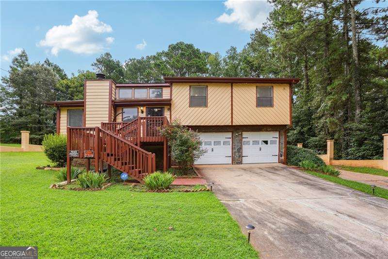 Charming 4 bedrooms 3 bath home with no HOA and 5 car garage! This spacious home features 2 full primary suites, ideal for multi-family living or extended guest stays. Enjoy 3 full bathrooms, an open concept layout, and a flat, usable backyard with endless potential for outdoor living! The open main living area offers great flow between kitchen, dining, and 2 living rooms perfect for everyday living and entertaining. Each primary suite includes a private bath and ample closet space. Two additional generously sized guest bedrooms that share a hall bath. Basement offers a bonus room perfect for a home office, gym, playroom, or media space. Home has a 5 car garage providing ample room for vehicles, storage, or workshop needs. Close to shops, restaurants and highways I-20 and I-285.