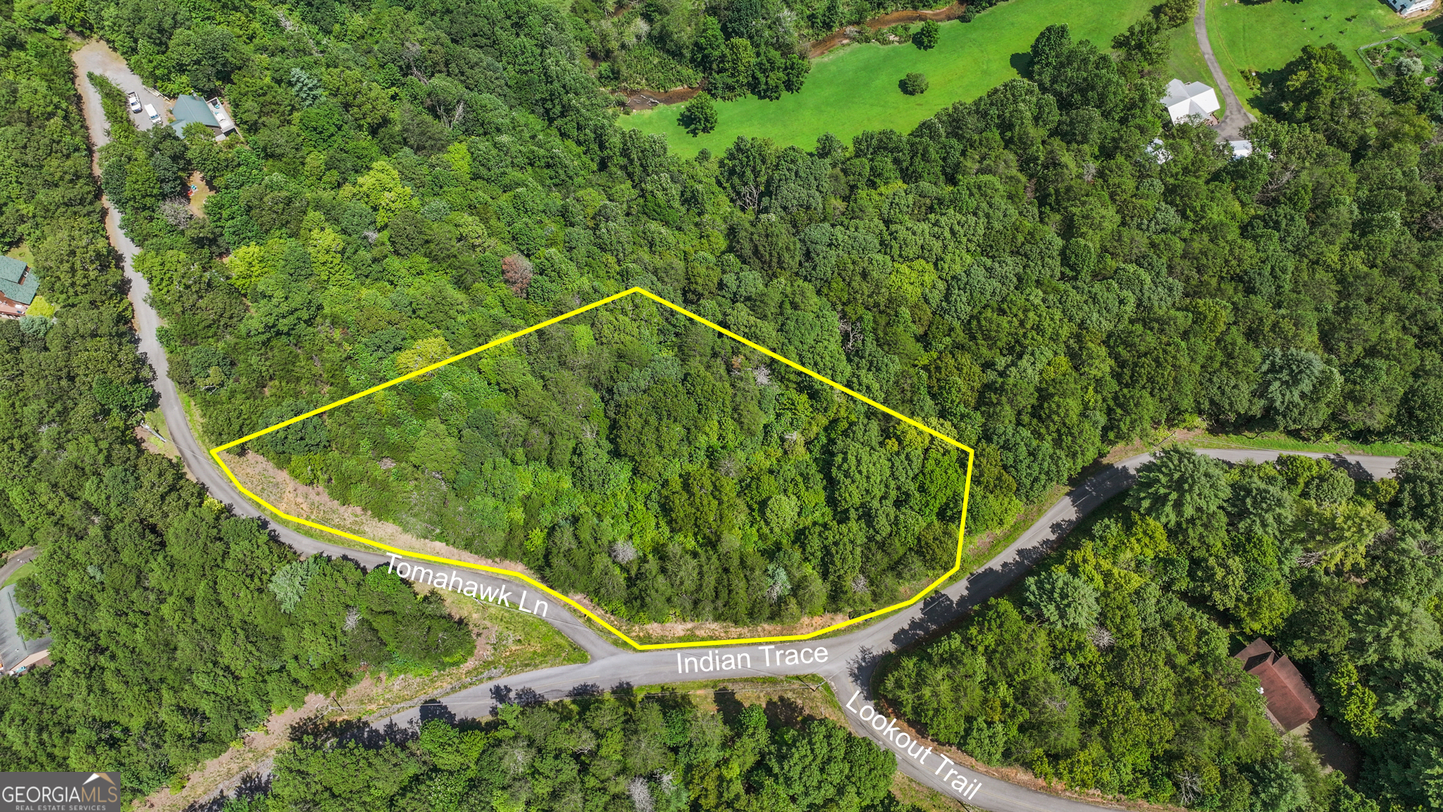 1.84-acre corner lot for sale in Riverwood Meadows II, Mineral Bluff. Located just moments away from downtown McCaysville/Copperhill, Horseshoe Bend Park, the Toccoa River, and downtown Blue Ridge, this spacious lot offers paved roads and access to public utilities. With mountain views and the tranquil sounds of Wolf Creek nearby, this is the perfect location to build your dream home. Builders, don't miss out on this opportunity - bring your plans and start building today! There are pink ribbons marking the pins in place.