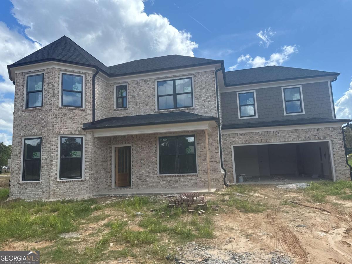 Built by SPI Homes and Crescent Homes, Peachtree Glen is a new home community in Lawrenceville, Georgia. Homesite 1, Glenville Plan, offers 5 bedrooms, 4 full baths, and luxury finishes throughout. This home showcases an open-concept design with a shiplap-accented fireplace flanked by open shelving and a chef's kitchen equipped with quartz countertops, ceiling-height cabinetry, a five-burner gas cooktop with a pot filler, and a walk-in pantry with custom shelving. Additional highlights include a formal dinning room, breakfast room, guest suite, butler's pantry and mudroom. Upstairs, the oversized primary suite features a spa-like bath with a freestanding soaking tub, quartz countertops, and an expansive walk-in closet. A secondary bedroom suite and two additional bedrooms with a Jack-and-Jill bath provide ample space, while the upstairs laundry room with sink adds convenience. Elevated details throughout include shiplap accents, crown molding, coffered ceilings, judges paneling, LVP flooring. Each home comes with Blinds on all operable windows and a refrigerator. Peachtree Glen is conveniently located across the street from Freeman's Mill Elementary and is within 4 miles of Interstate 85, Mall of Georgia, Coolray Field, Sprouts, and Rabbit Hill and Little Mulberry Parks. $10,000 buyer incentive with preferred lender. GPS Address: 2300 Old Peachtree Road, Lawrenceville 30043. Special Builder Incentive with our Preferred Lenders! There are some construction photos. ALL OTHER PHOTOS ARE STOCK PHOTOS OF A PREVIOUS BUILD. Professional photos coming soon.