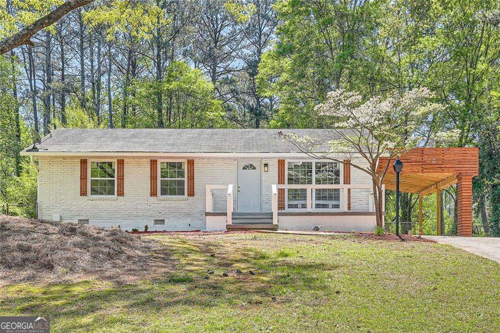 Welcome to 4201 Regal Ridge Drive, a thoughtfully renovated ranch-style home located on a quiet street in Austell. This 3-bedroom, 2-bath residence offers a blend of classic charm and modern updates, ideal for first-time buyers, those looking to downsize, or anyone seeking the ease of one-level living. Recent improvements include new wide-plank flooring throughout the home, an open-concept living area, and an eat-in kitchen featuring brand-new stainless steel appliances, white shaker cabinetry, and quartz countertops. One bathroom has been fully renovated, while a second bathroom was recently added, providing additional functionality and value. Step outside to a covered patio, perfect for year-round enjoyment. A newly constructed carport provides covered parking and enhances the home's curb appeal. Conveniently located minutes from shopping, dining, and top-rated schools, with quick access to I-20 for commutes to Midtown or west toward Douglasville. This home is move-in ready with quality finishes throughout. Schedule a showing today to experience everything 4201 Regal Ridge Drive has to offer.
